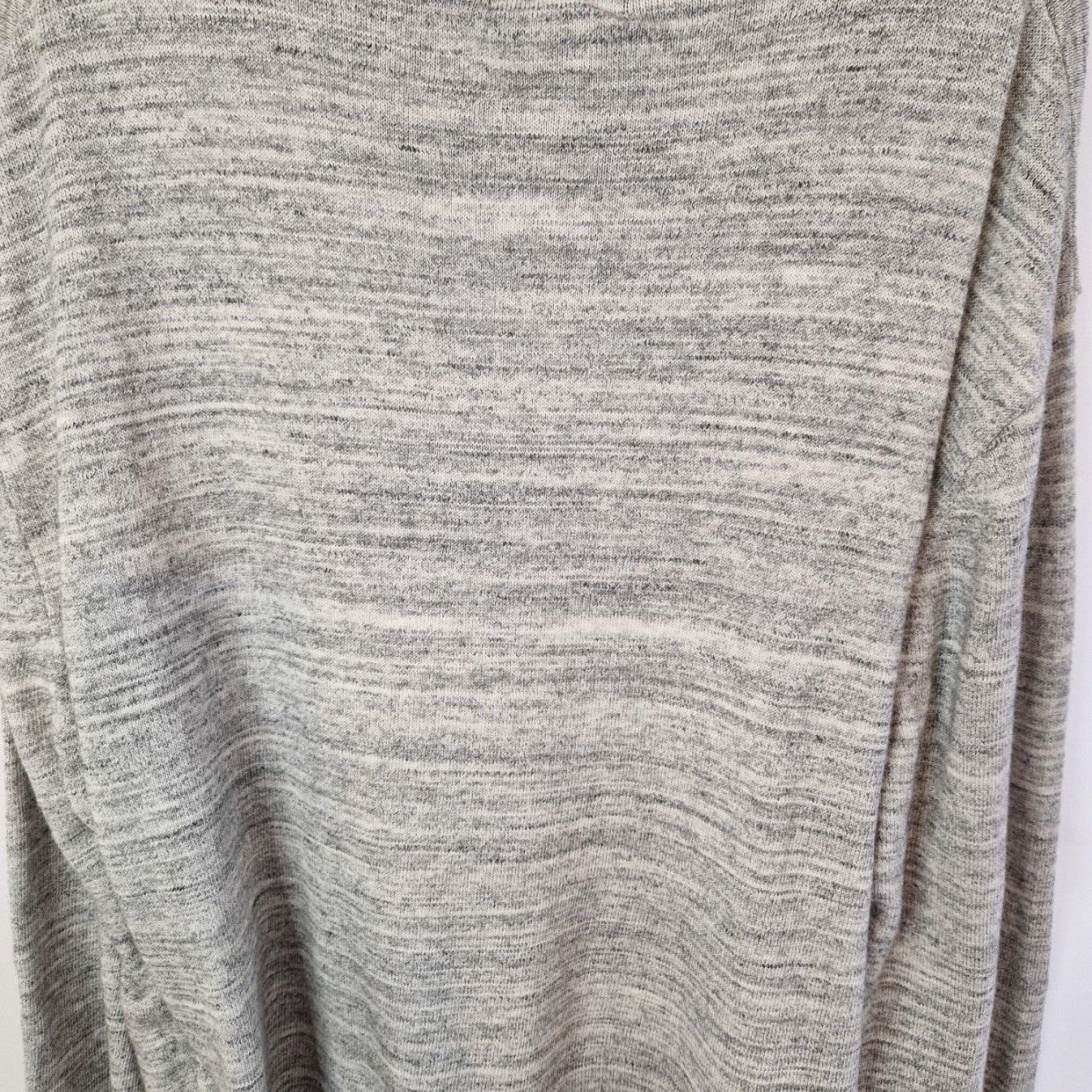 A grey long-sleeve knit pullover with a quarter-zip neckline.