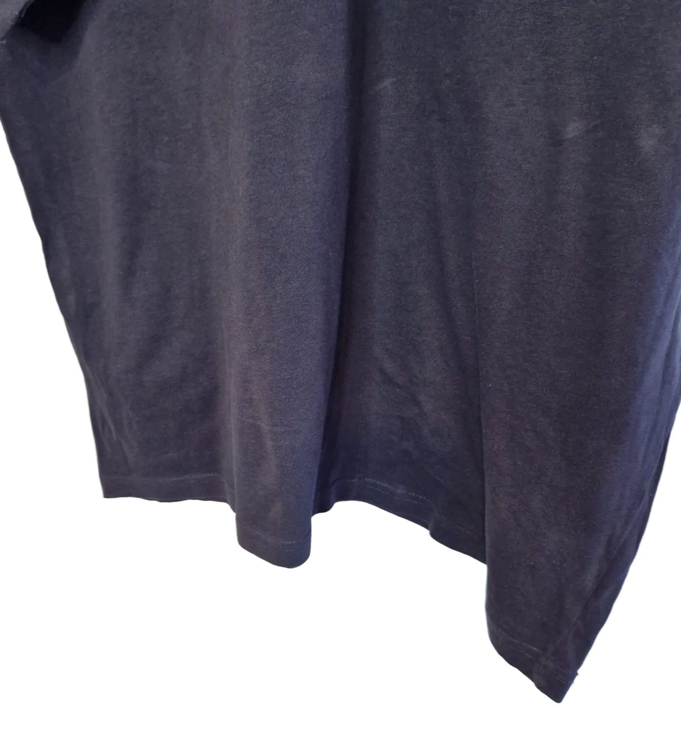A close-up view of the hem and fabric of a blue Donnay men's V-neck cotton jersey t-shirt.