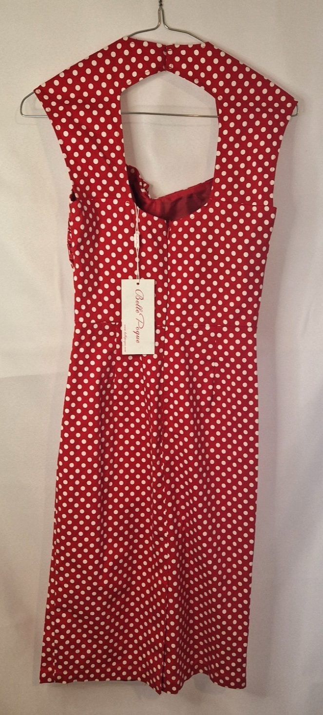 A red and white polka dot vintage-style halter dress with a sleeveless fit and flare silhouette.