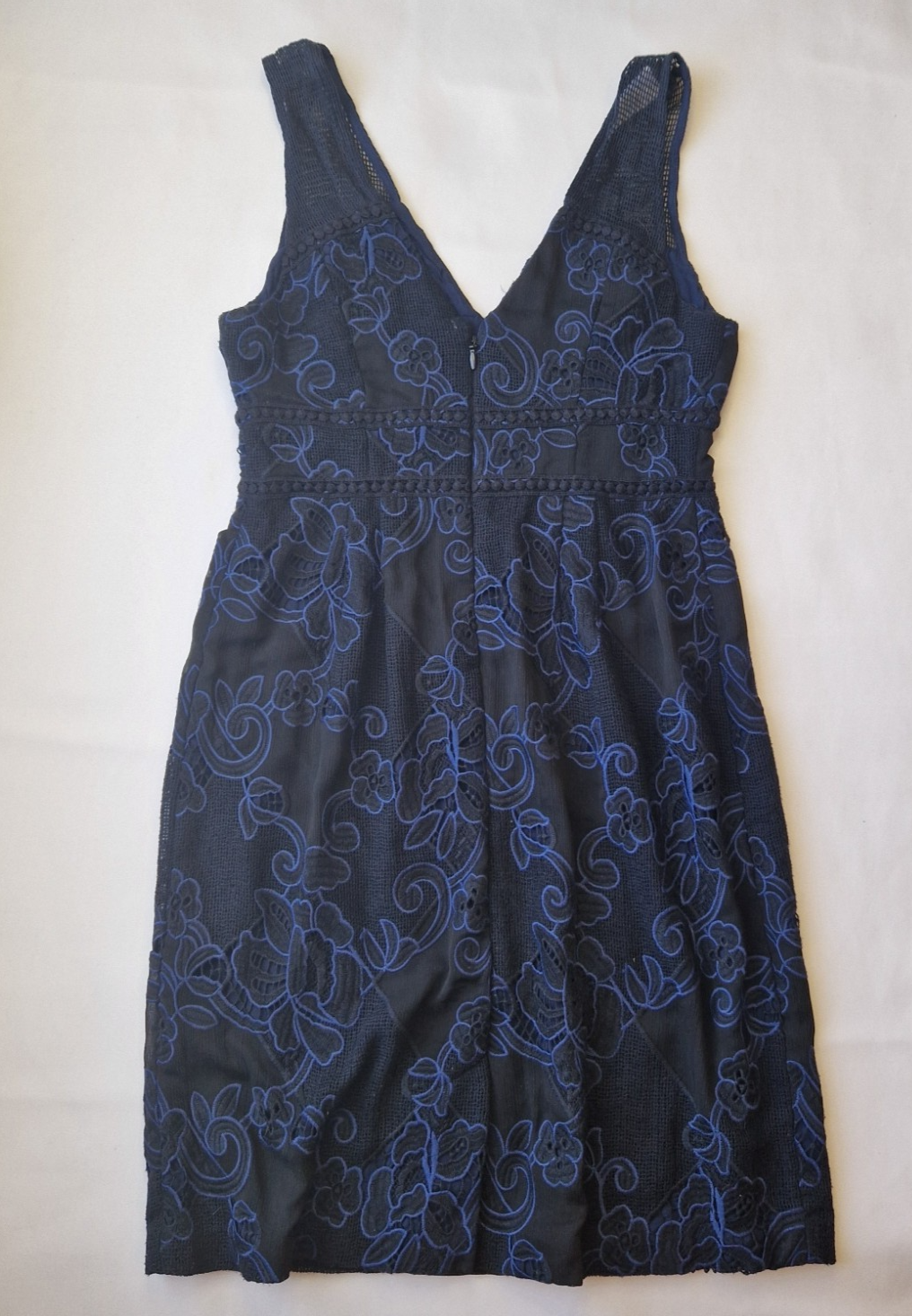 Moulinette Soeurs sleeveless knee-length dress in black lace with blue floral embroidery.