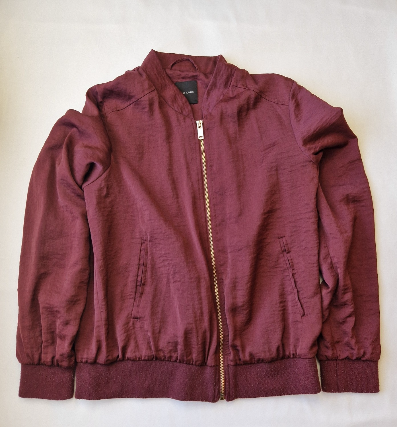 A maroon New Look lightweight bomber jacket with a full front zip and ribbed cuffs.