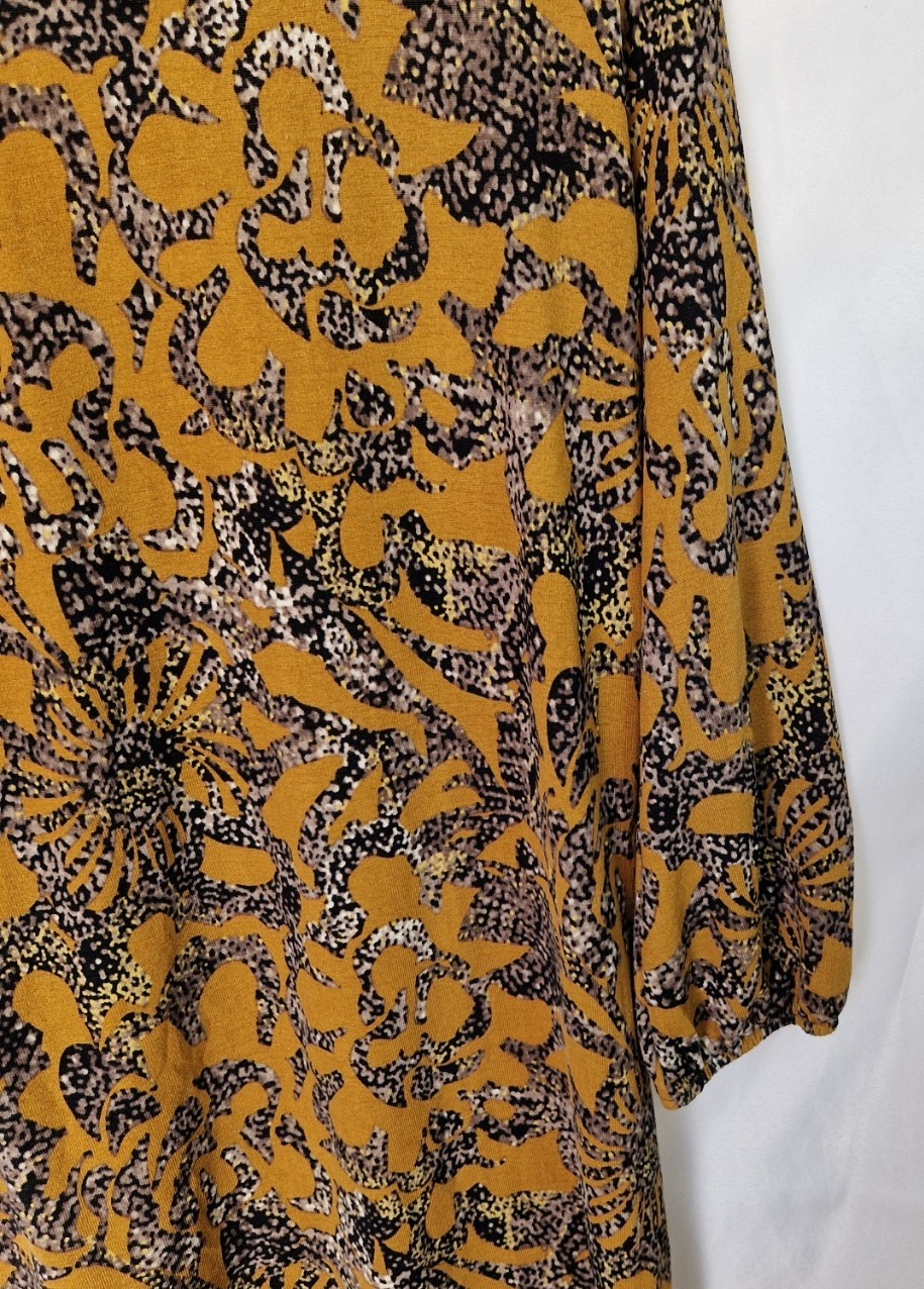 A yellow Klass long-sleeve tunic top featuring an abstract black and grey floral print.