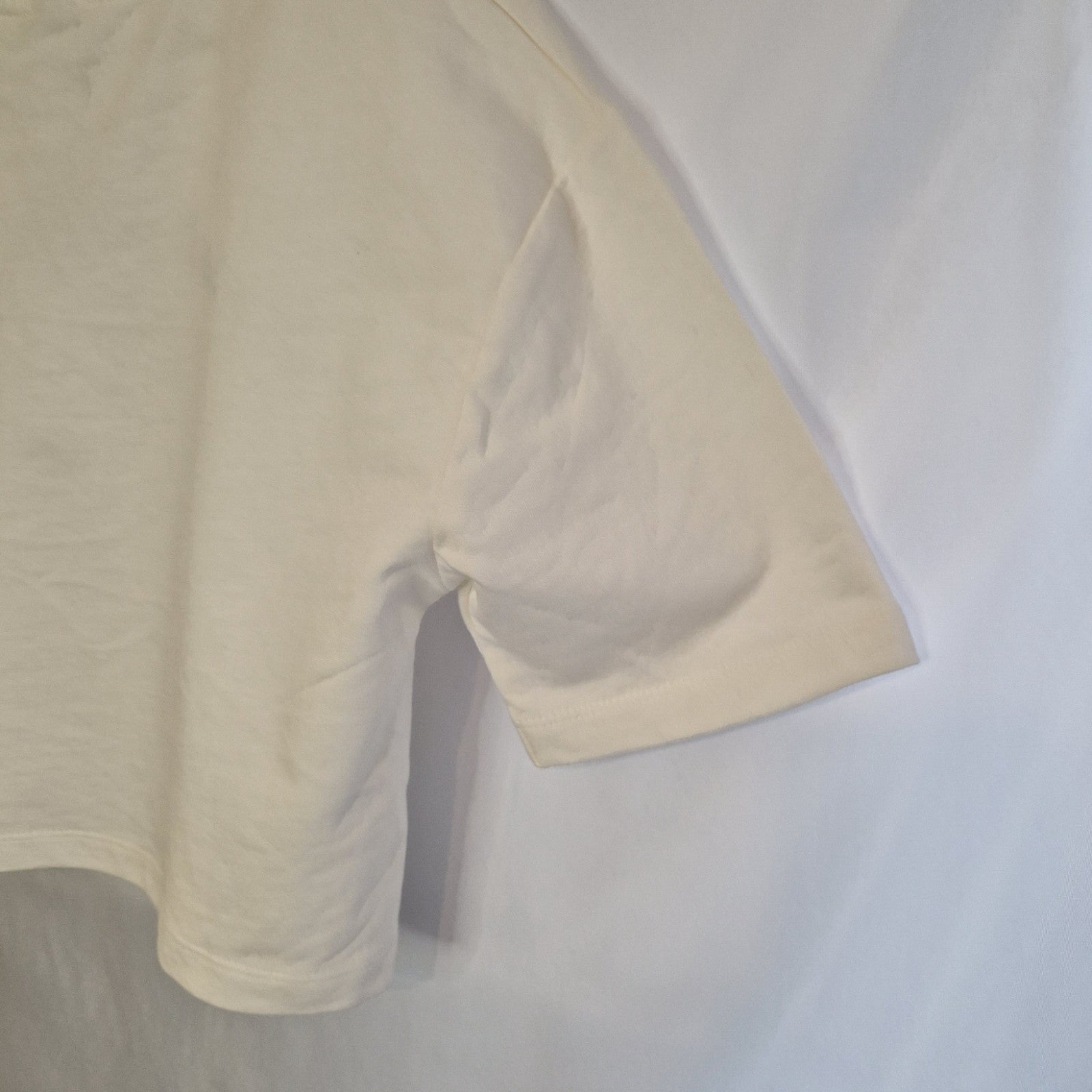 A plain white short-sleeved cotton t-shirt for toddlers.
