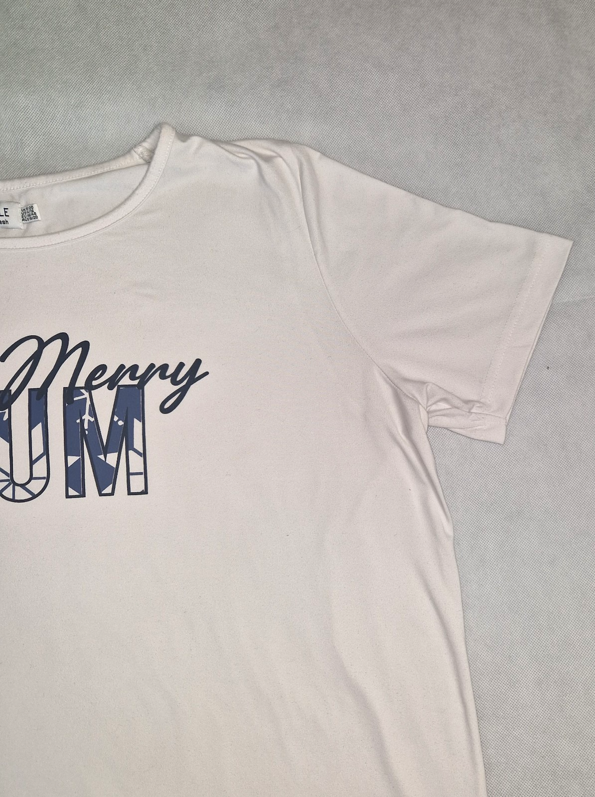 A white short-sleeved cotton t-shirt with a Merry Mum graphic print on the chest.