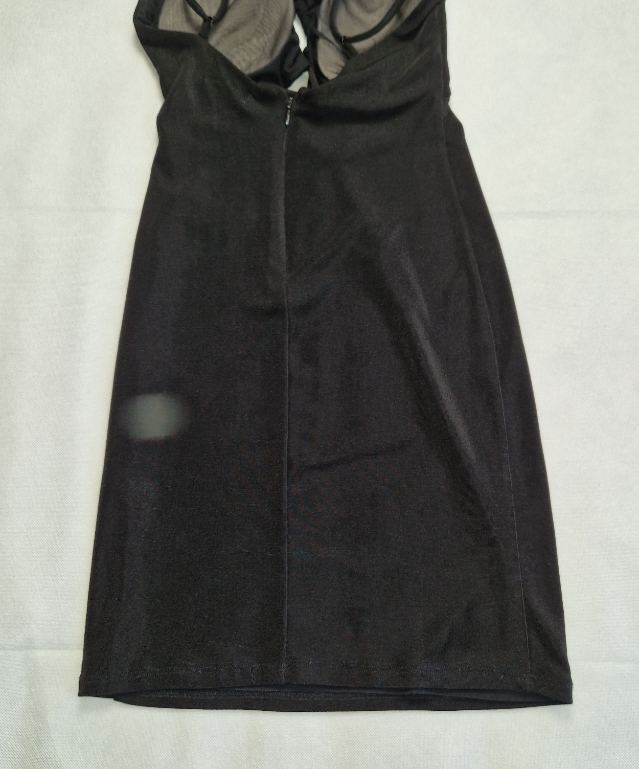 A black Bershka off-shoulder crop top with thin straps, integrated padding, and a back zip.