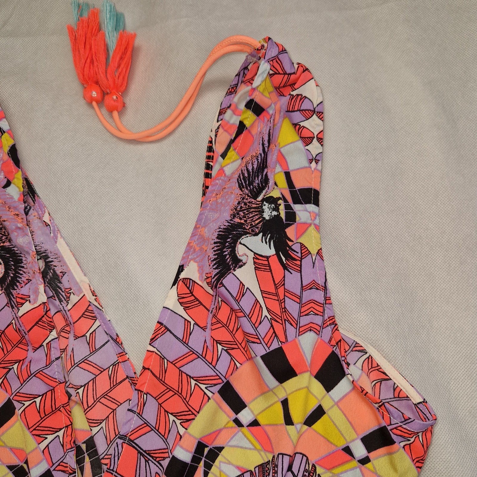 A multicoloured floral print playsuit featuring an off-the-shoulder neckline with tassel ties.