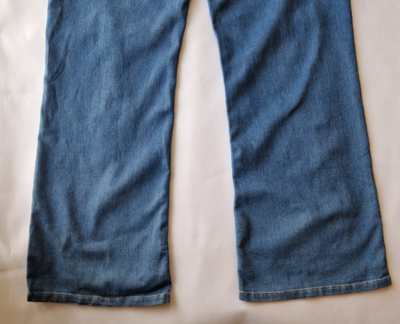 A pair of medium wash blue wide leg jeans with a high rise fit.