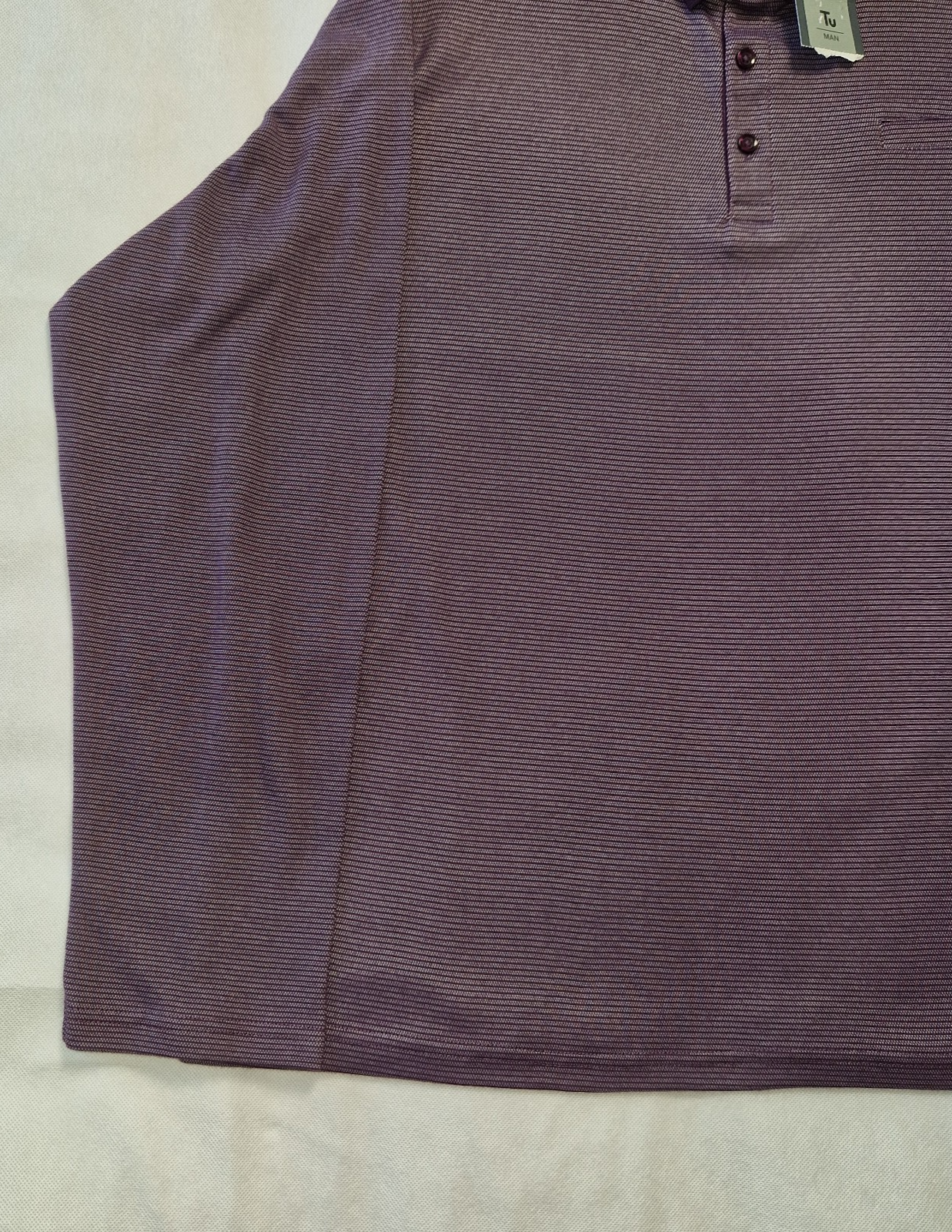 A purple, fine-striped polo shirt with a button-down collar and a relaxed fit.
