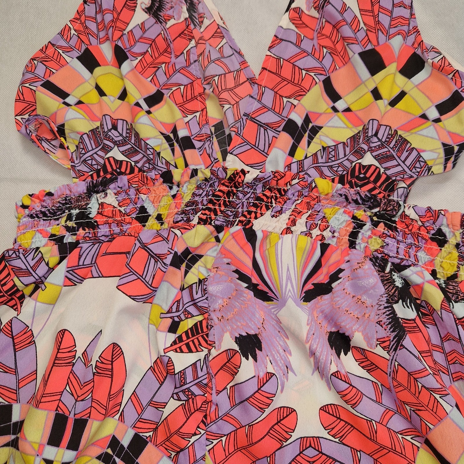 A multicoloured floral print playsuit featuring an off-the-shoulder neckline and elasticated waist.