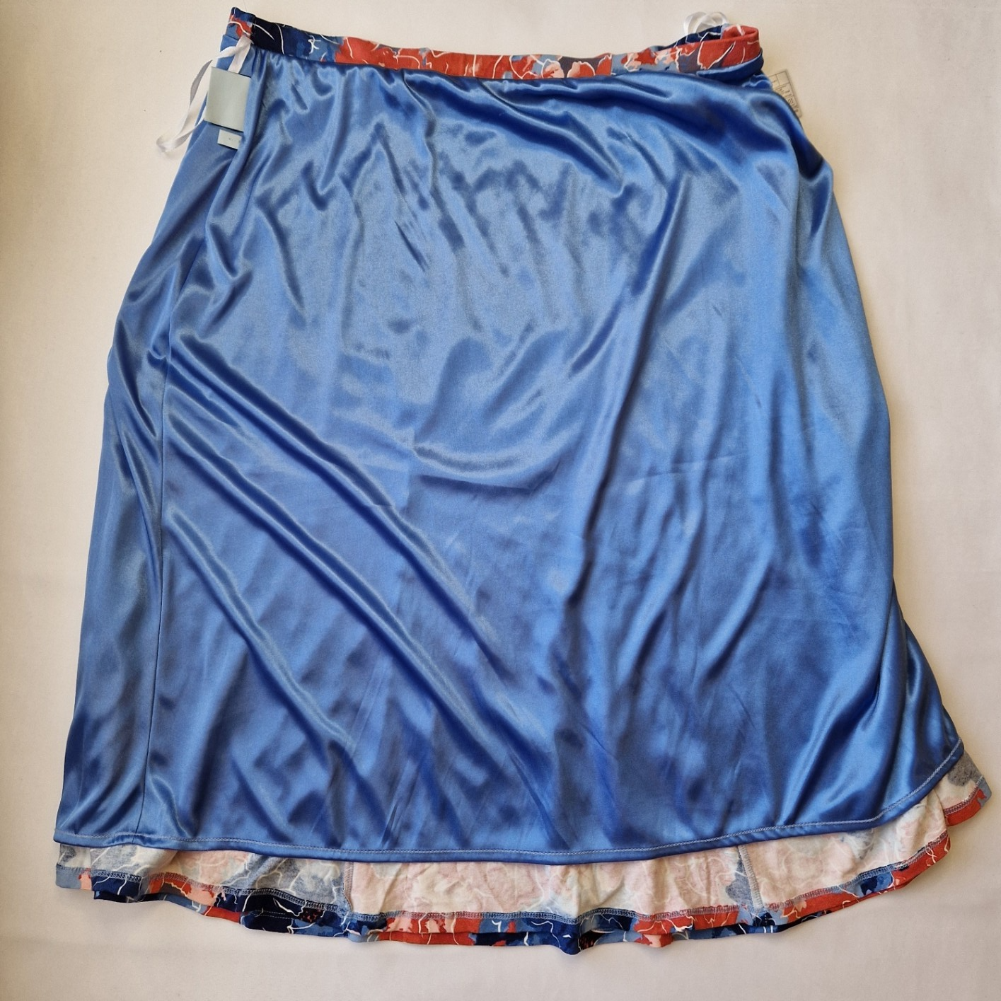 Honor Milburn floral asymmetric midi skirt with a blue satin lining and multicolour print.