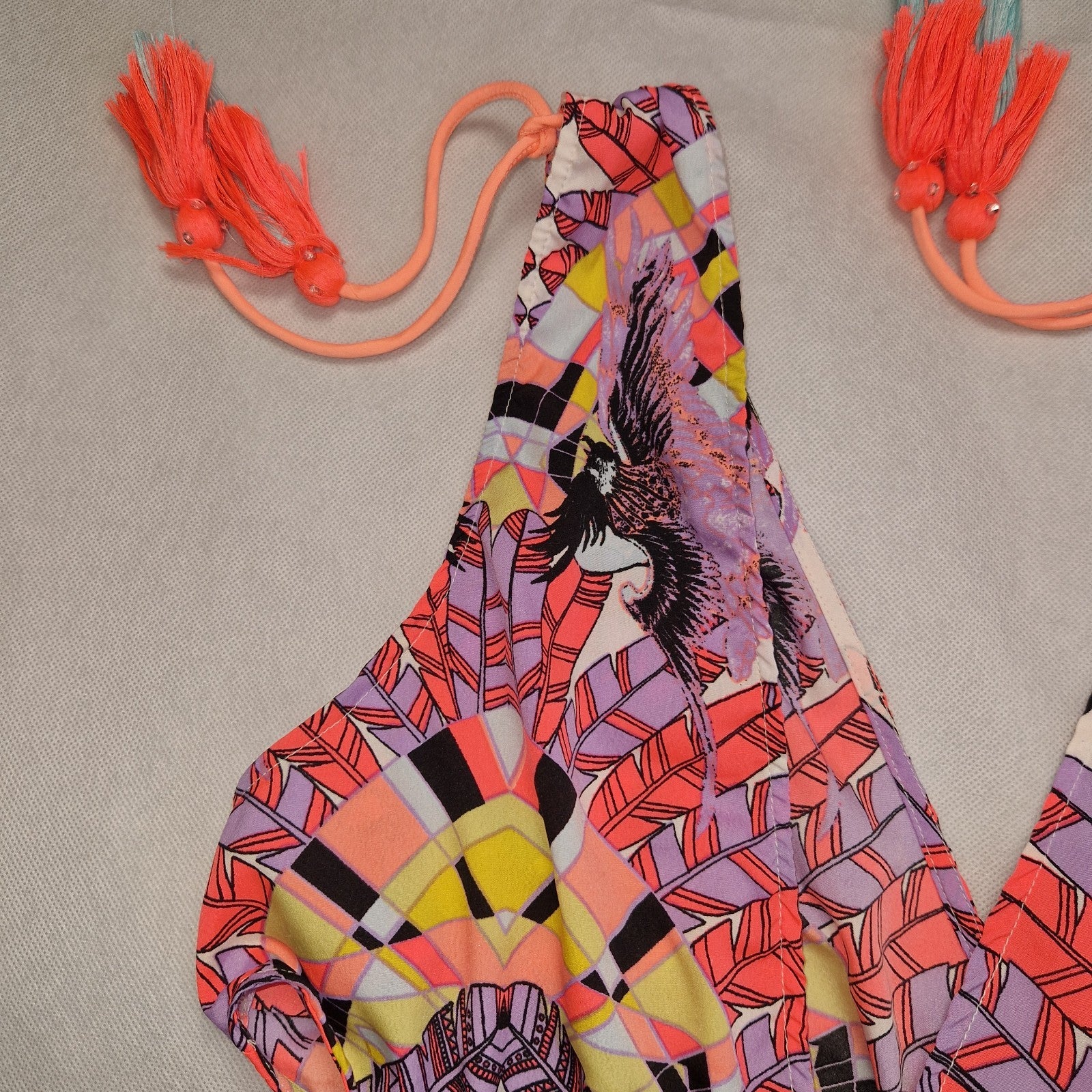 A multicoloured floral print playsuit featuring an off-the-shoulder neckline with tassel ties.