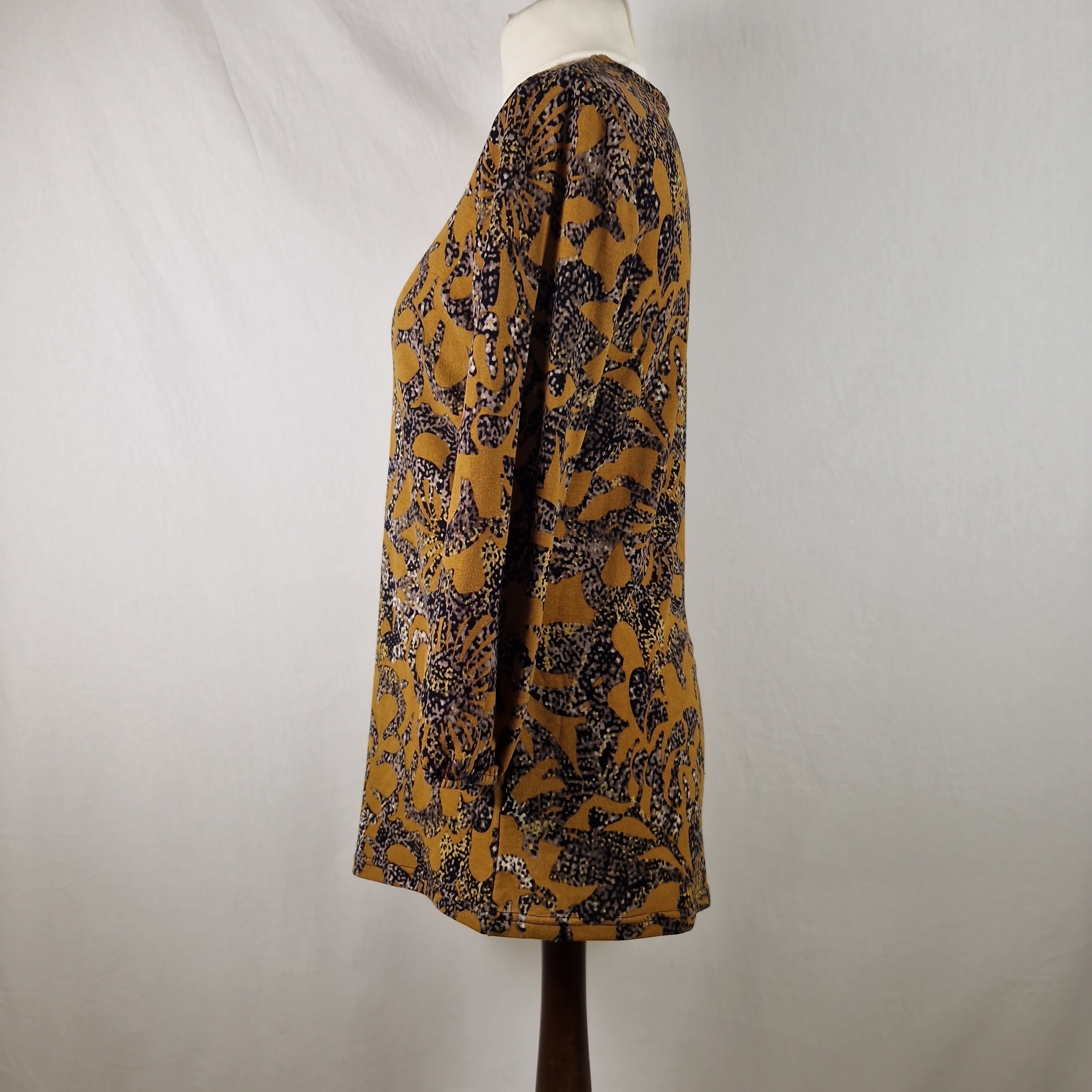 Mannequin wearing a patterned skirt with a plain background