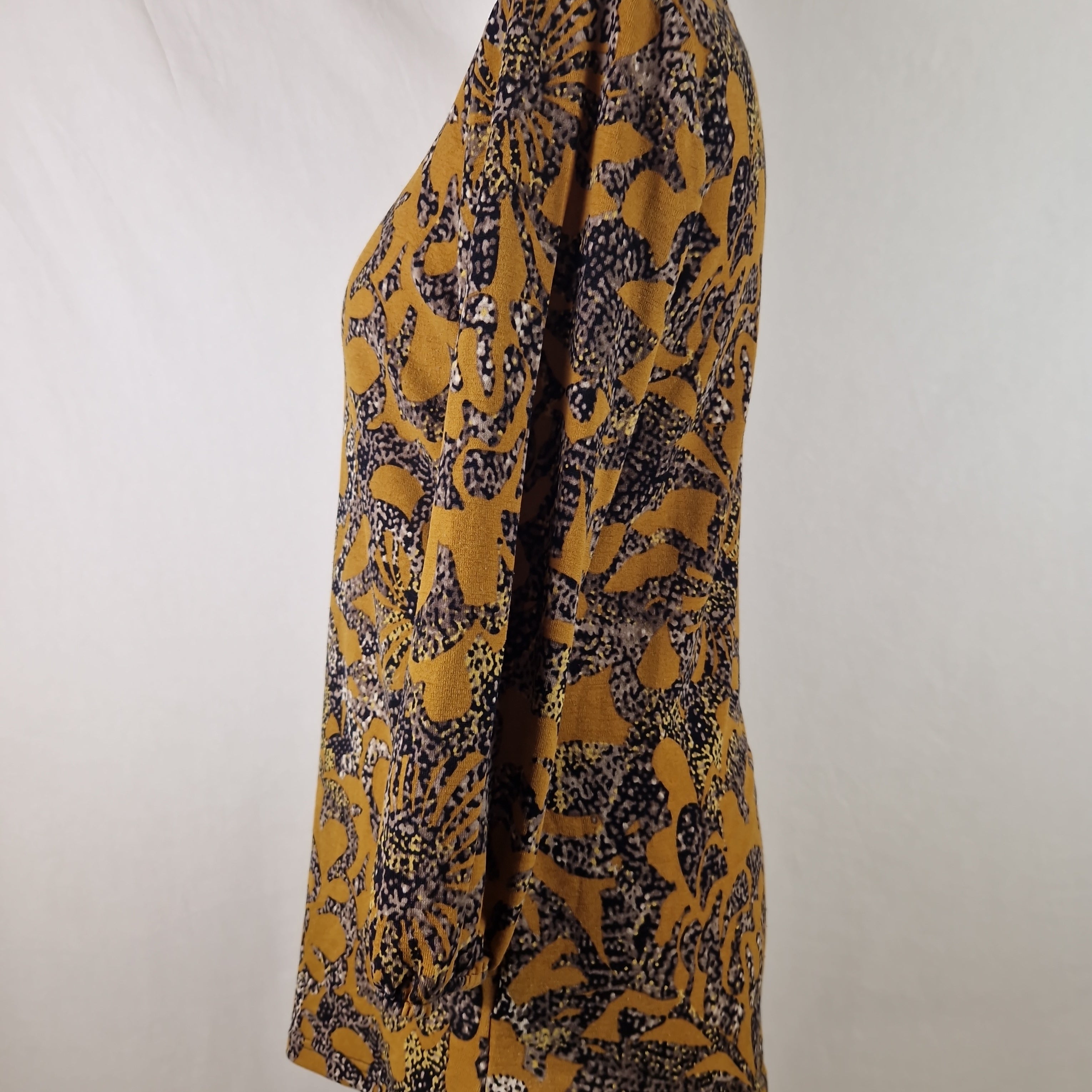 Yellow and black patterned scarf on a white background