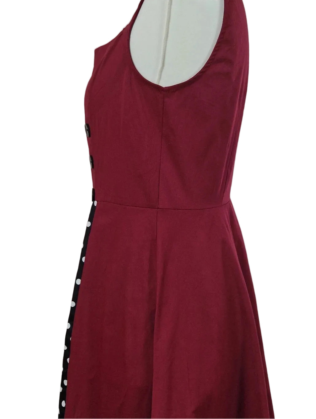 A sleeveless red A-line midi dress with a black and white polka dot side panel.