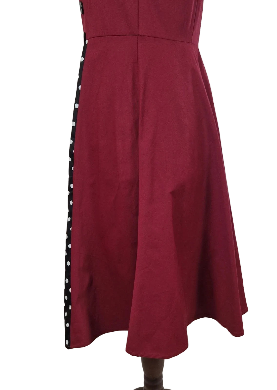 A sleeveless red A-line midi dress with a black and white polka dot side panel.