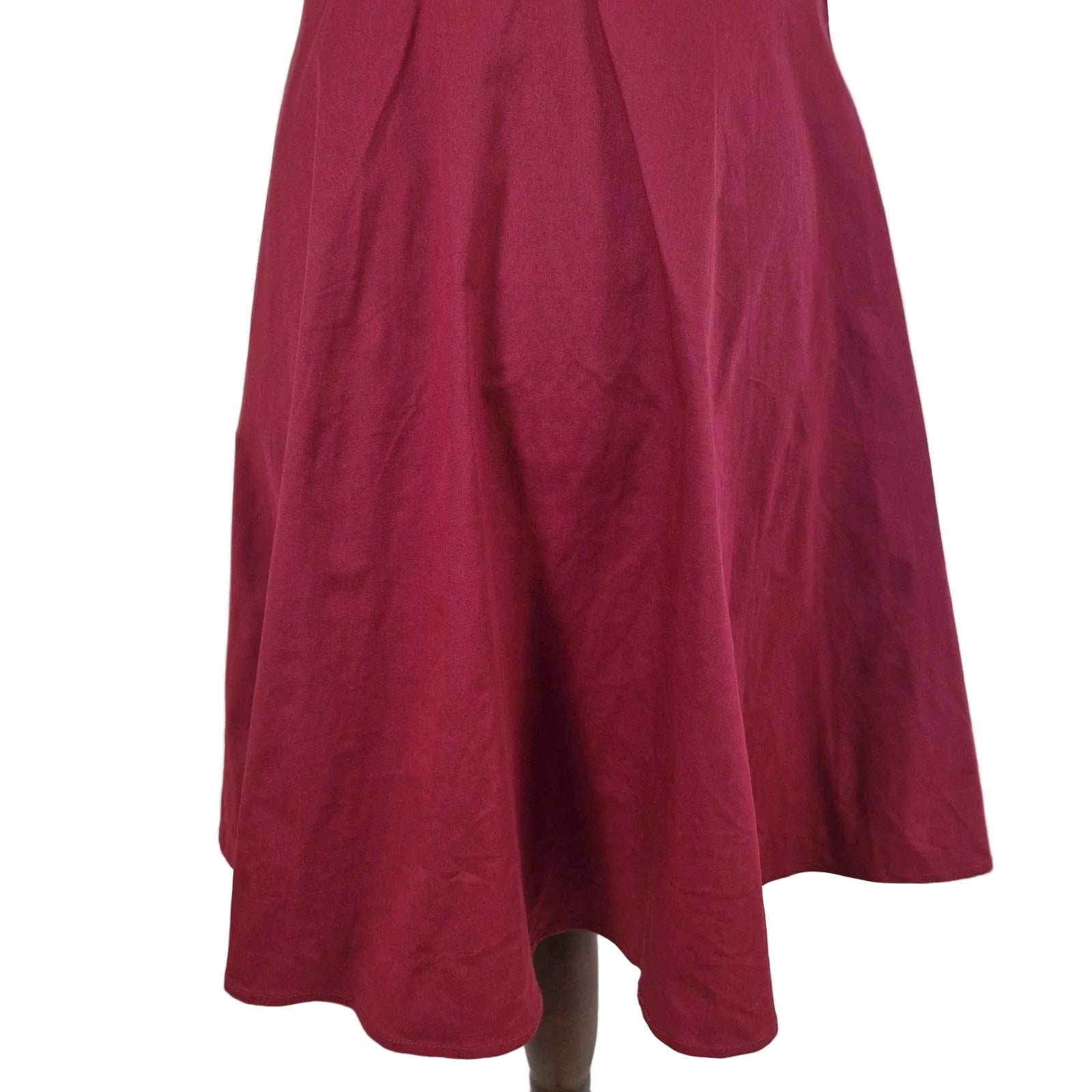 A red sleeveless A-line midi dress made from a cotton blend.