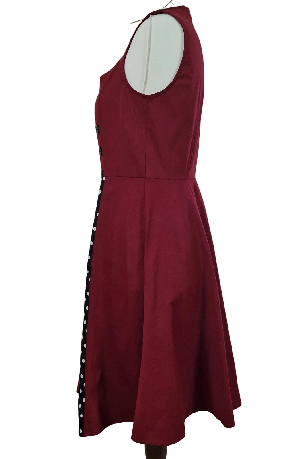 A sleeveless red A-line midi dress with a black and white polka dot side panel.