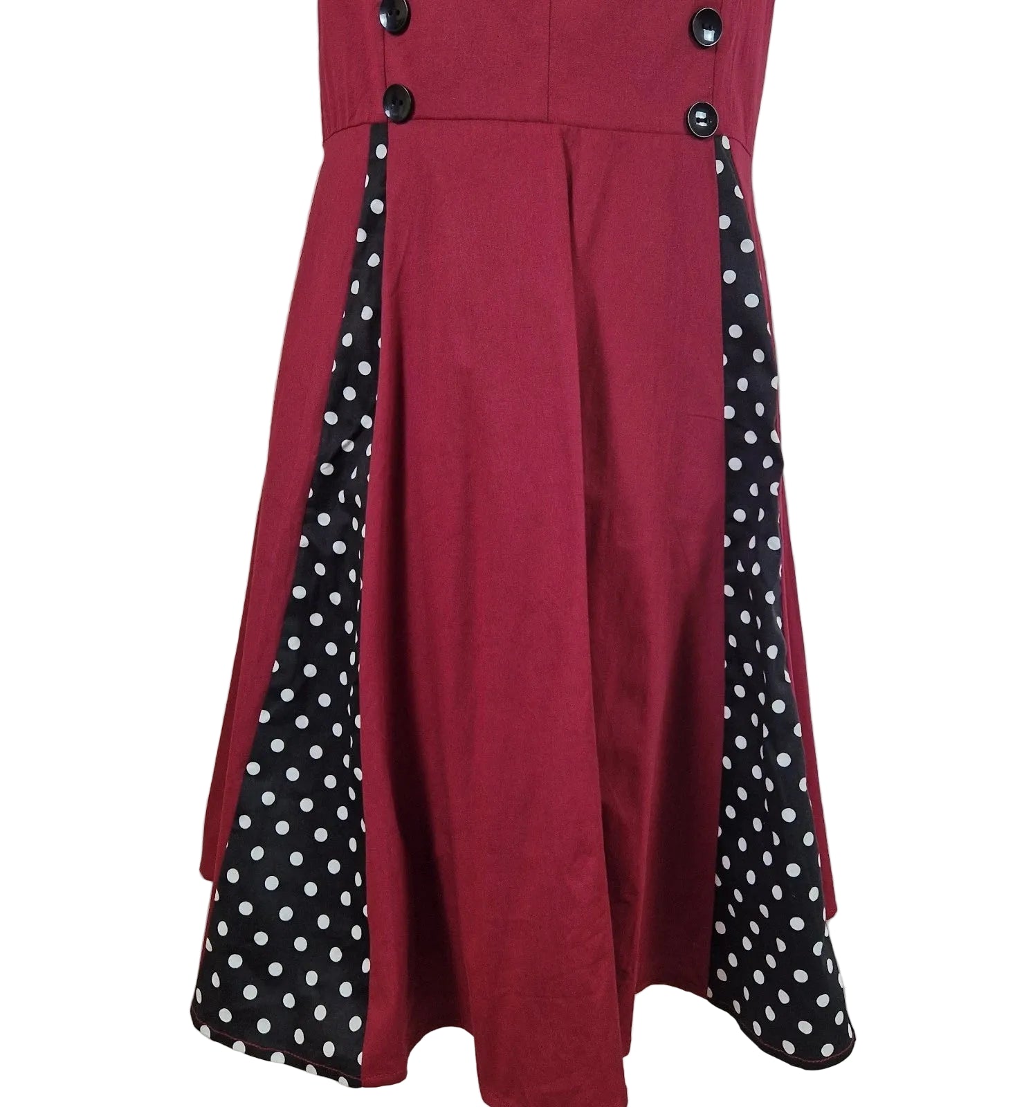 A red sleeveless A-line midi dress featuring black polka dot side panels and button accents.