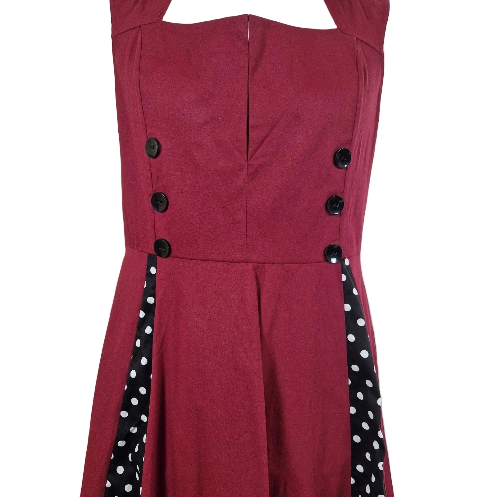 A sleeveless red A-line midi dress featuring a square neckline and black polka dot side panels.