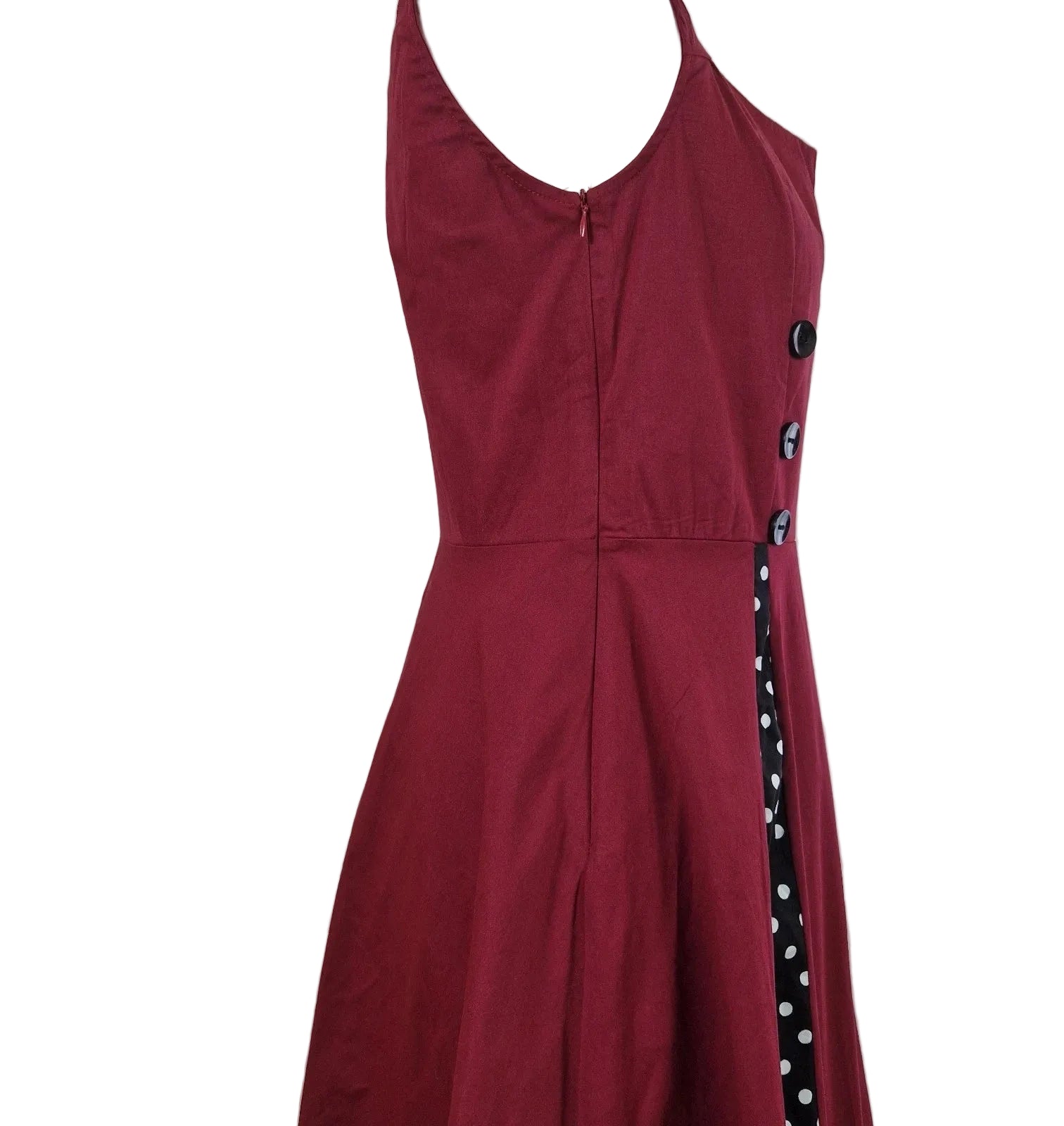 A sleeveless red A-line midi dress with a black and white polka dot side panel and button detail.