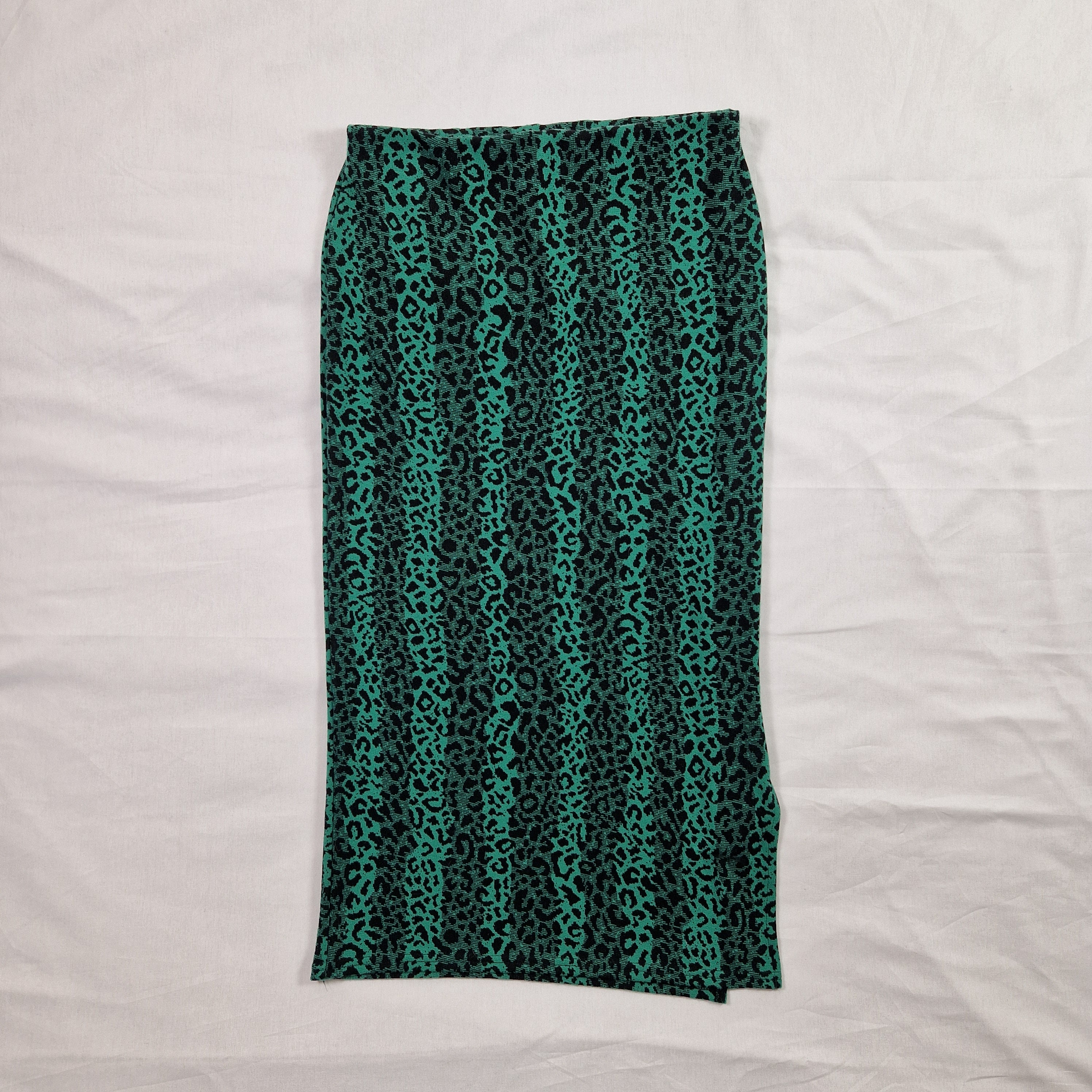 Teal and black patterned tube top on a white background