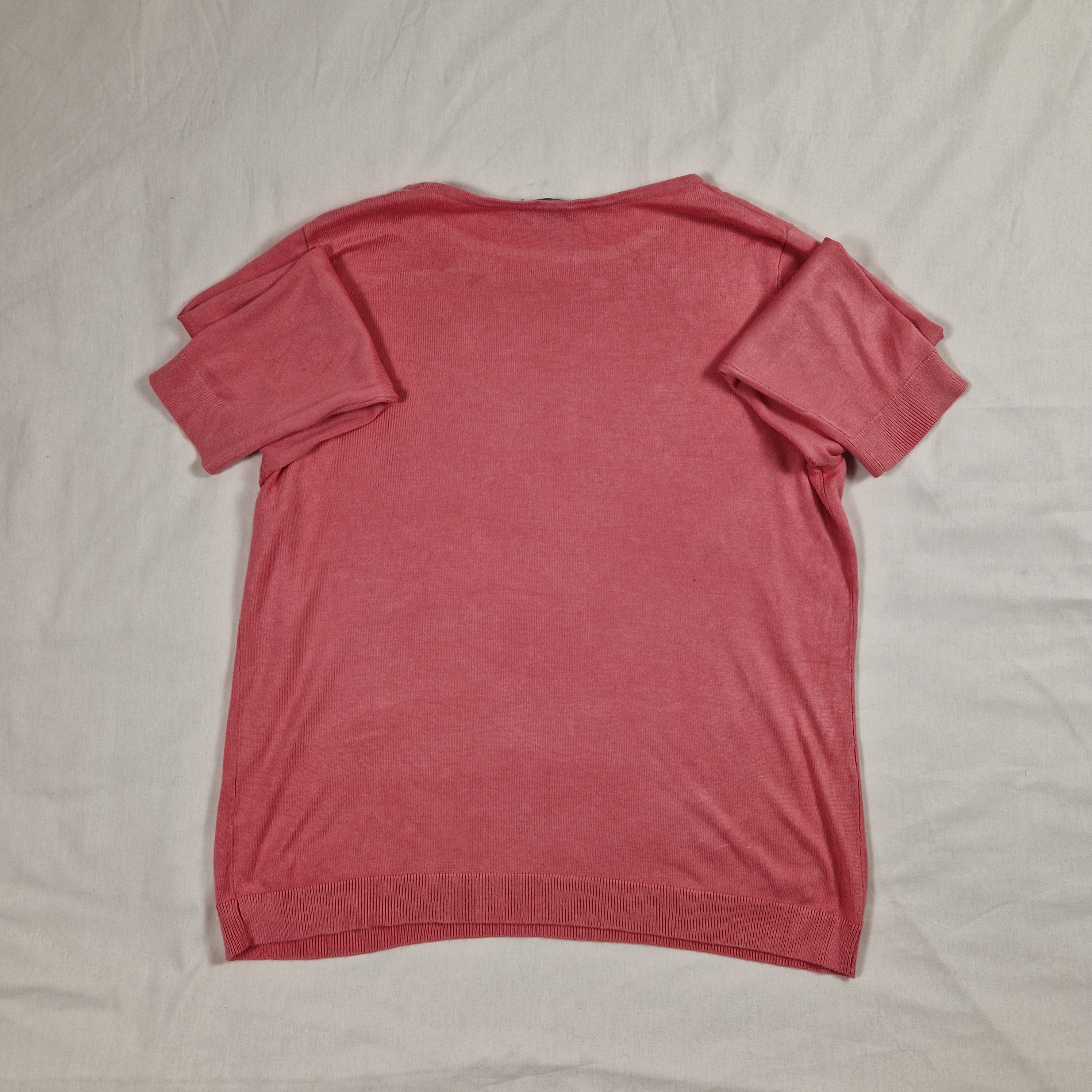 Pink sweater on a light gray background