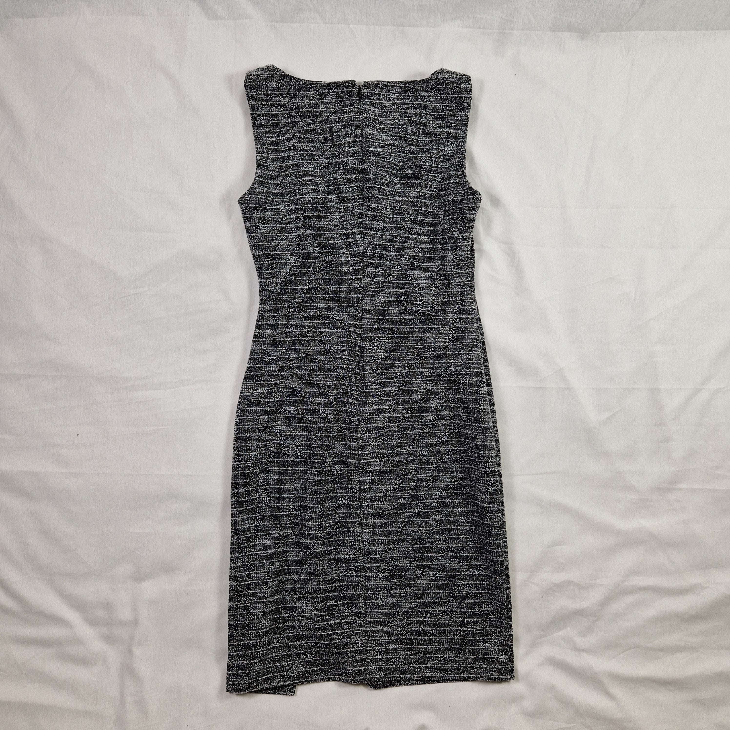 Gray knitted fabric on a white bedspread