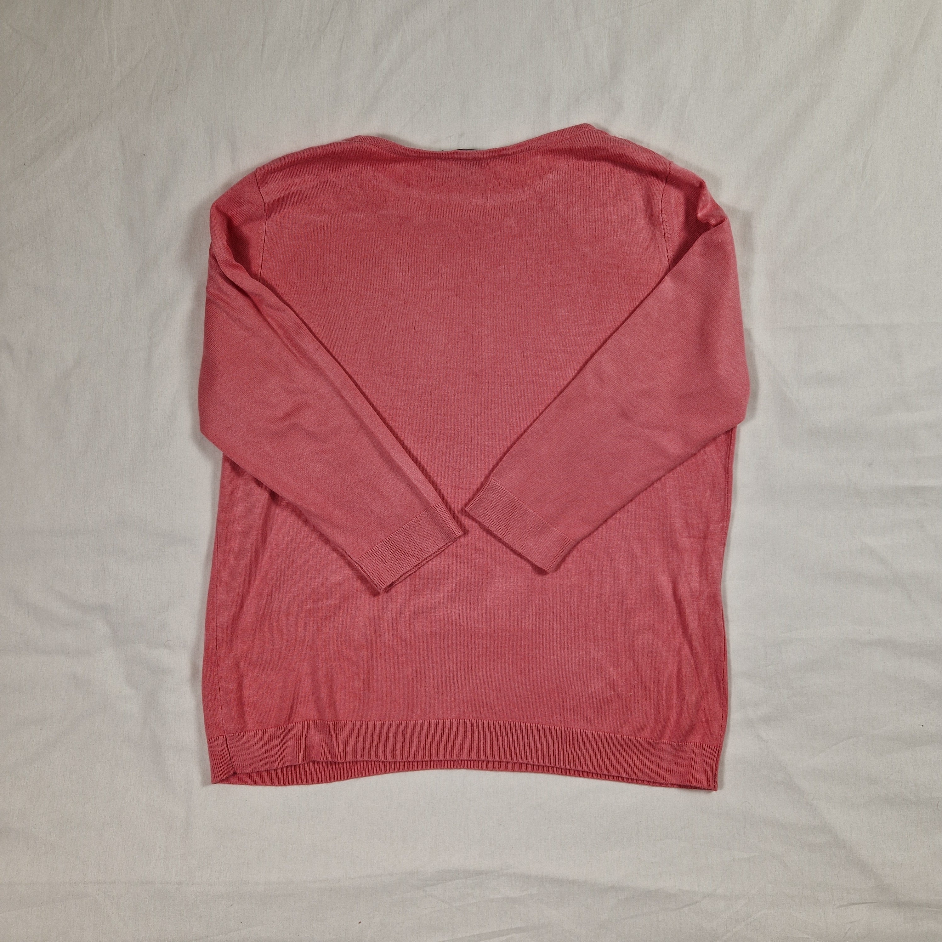 Pink sleeveless top on a light gray background