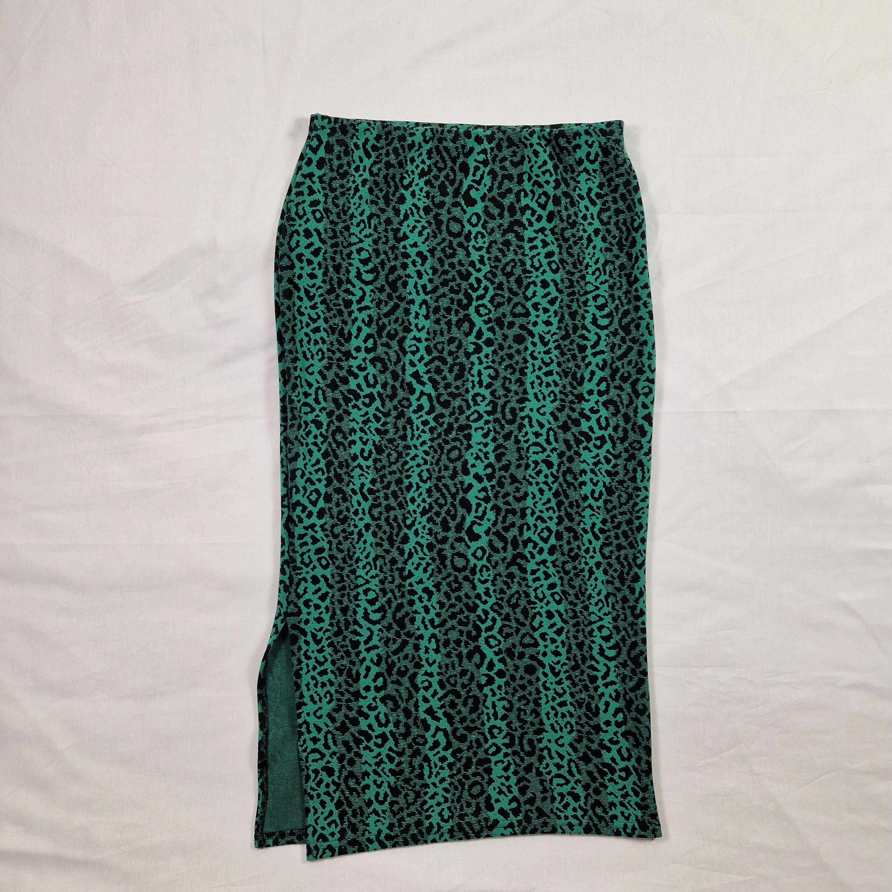 Green leopard print skirt on a light gray background