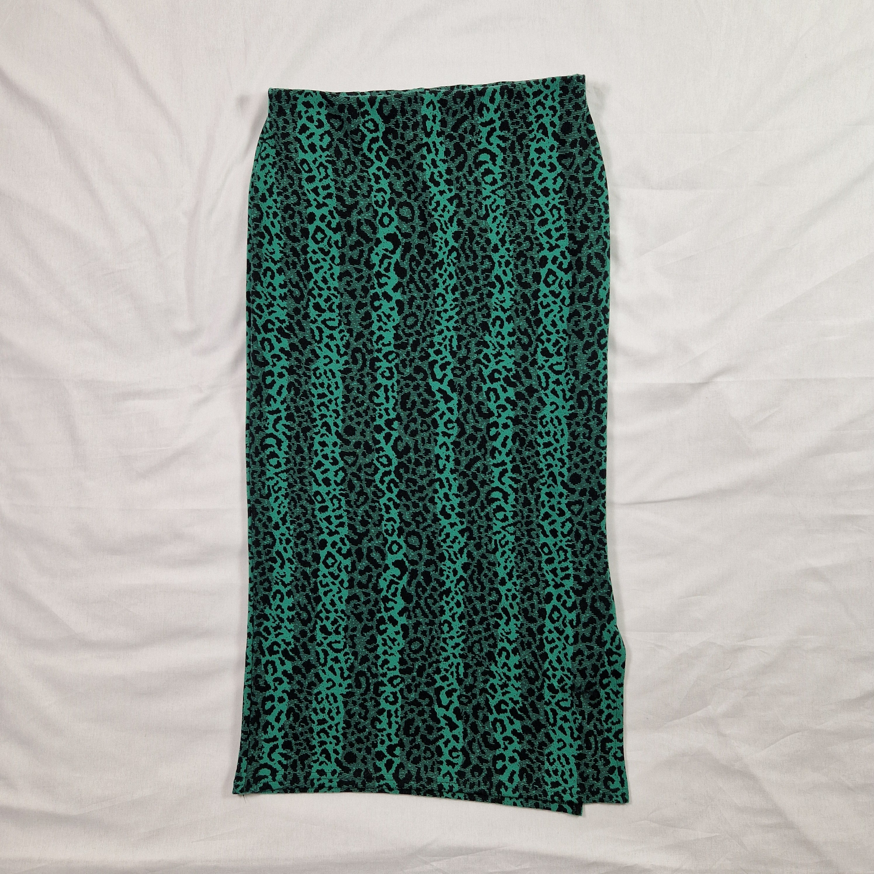 Green and black patterned tube top on a white background