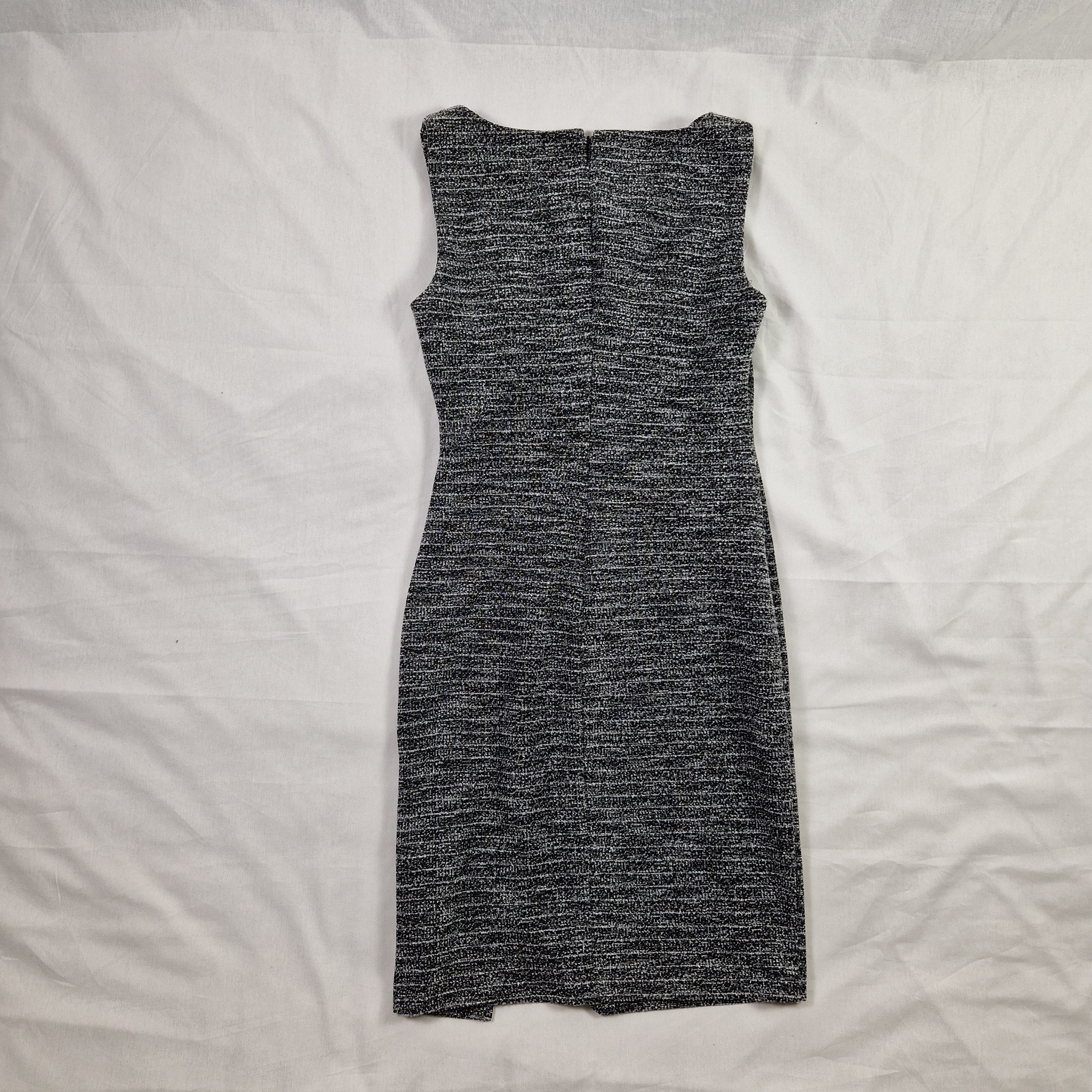 Gray ribbed knit sock on a white fabric background