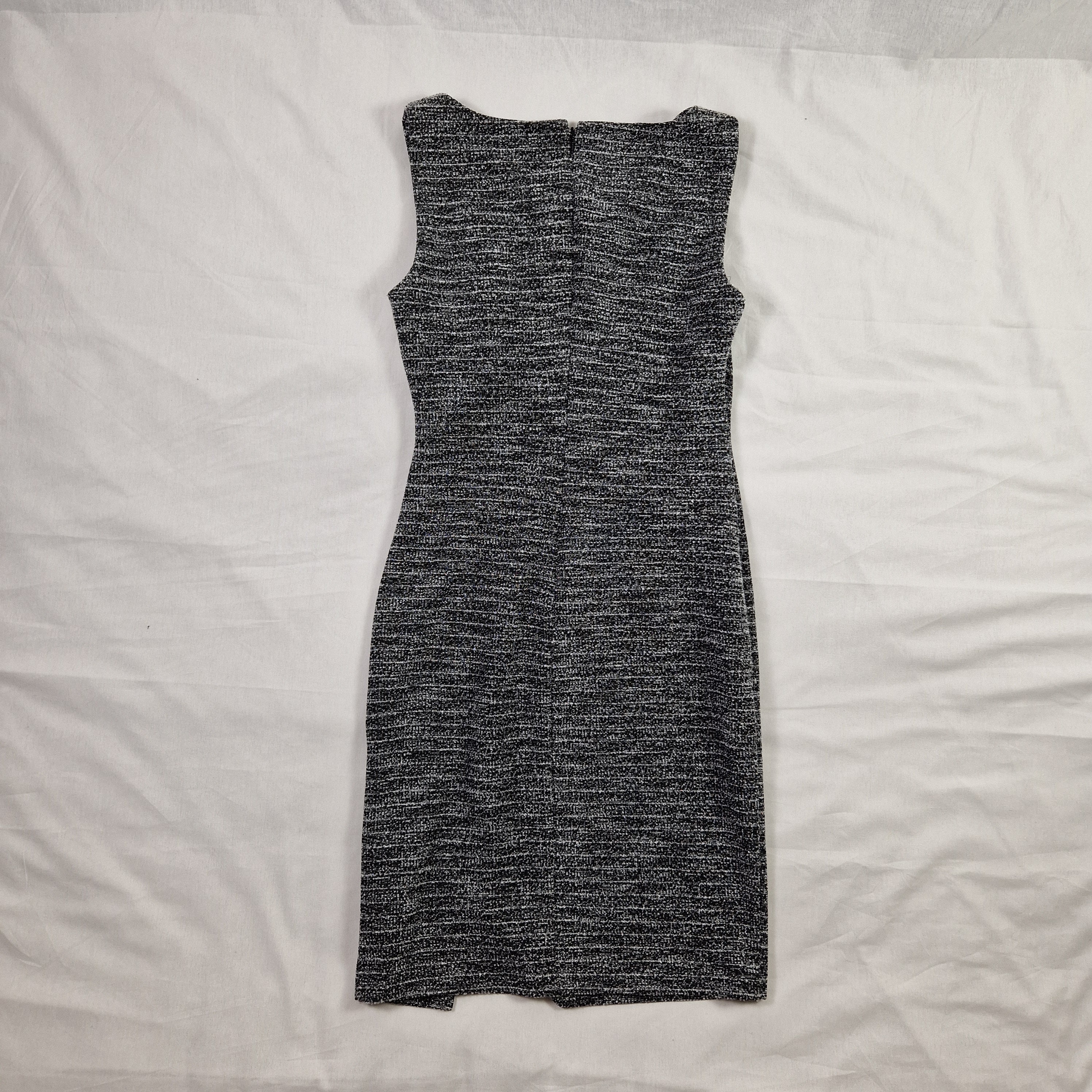 Gray knit dress on a white bed