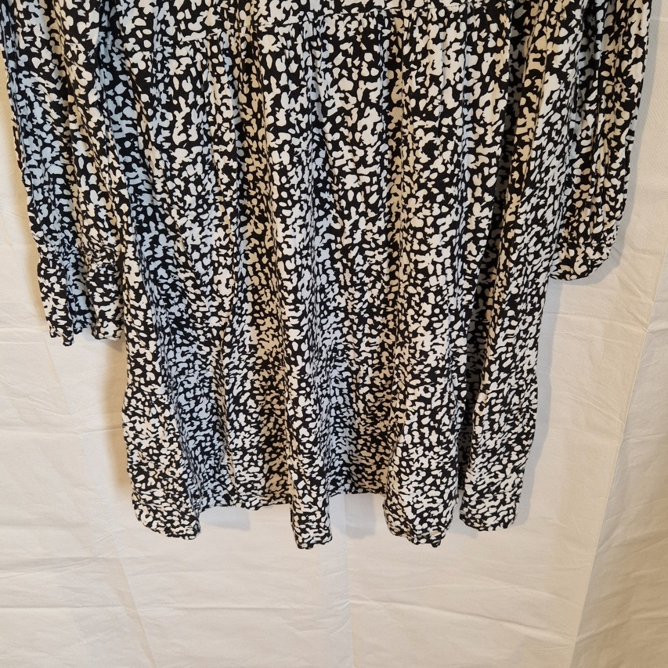 H&M black and white floral print midi dress with long puff sleeves and a ruffled hem.