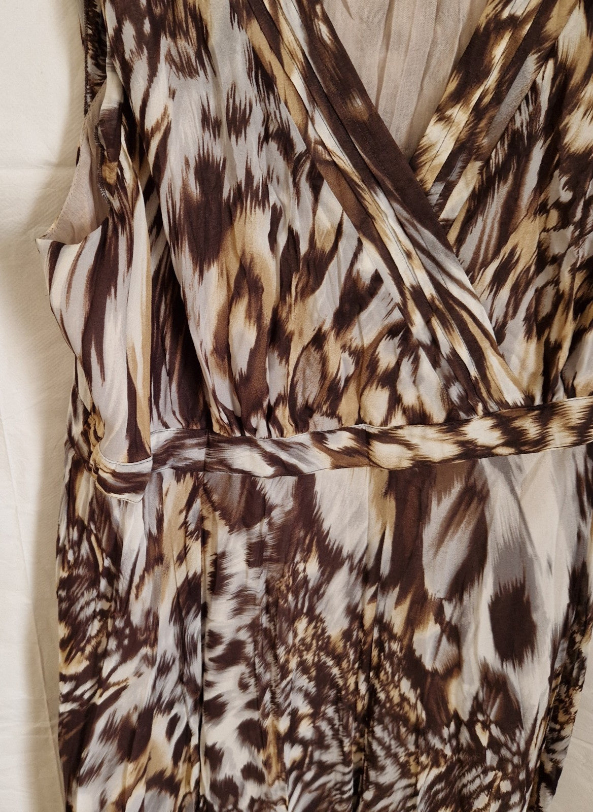 A brown and beige animal print chiffon maxi dress featuring a wrap-style bodice and waist band.