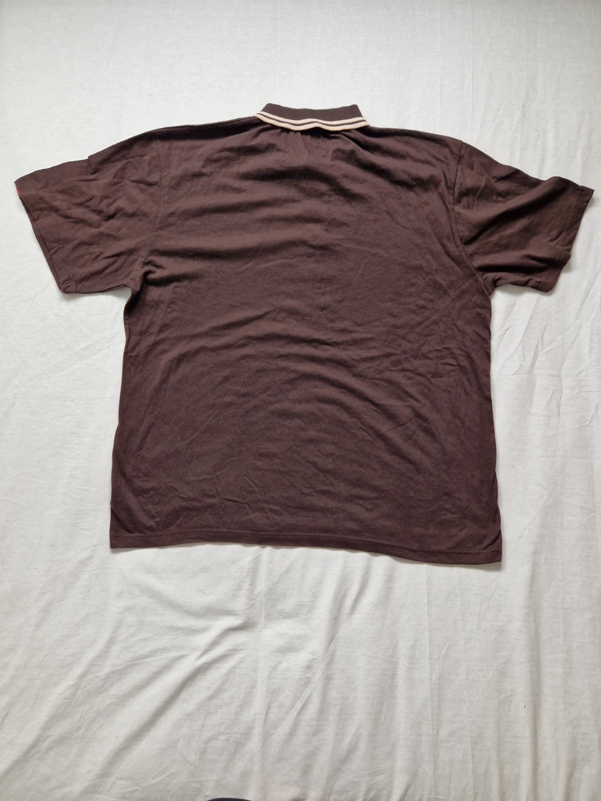 Brown polo shirt on a light gray background