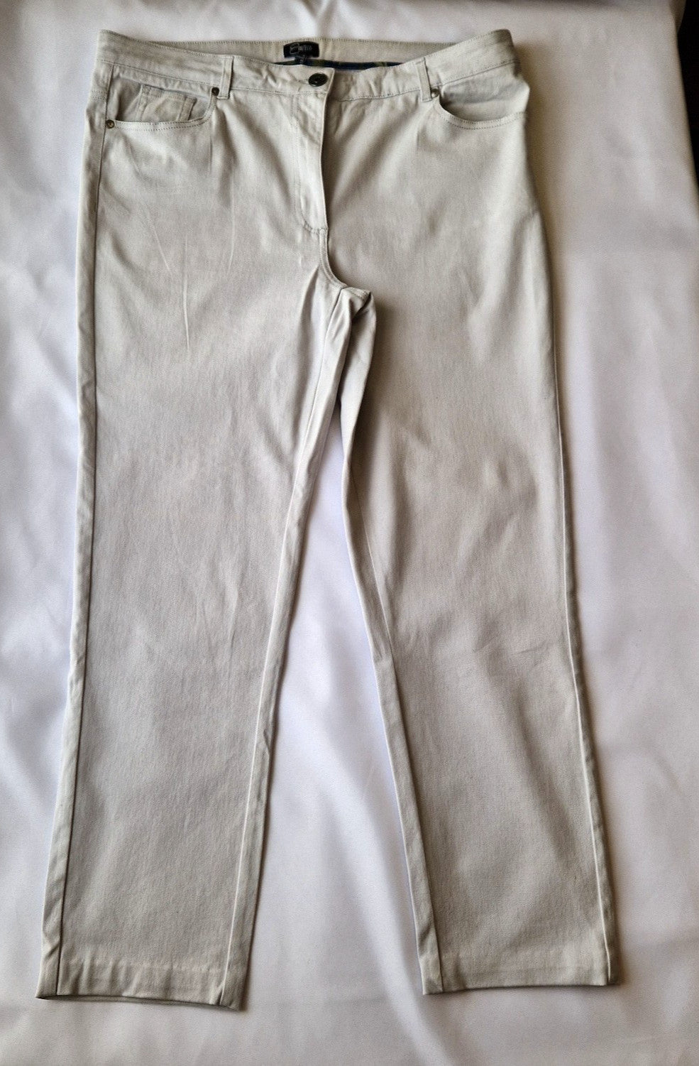 Emreco beige straight leg corduroy chino trousers with a zip and button closure.