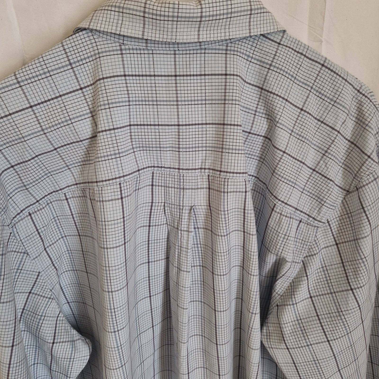 A long-sleeve Timberland shirt in a grey and blue check pattern with a back box pleat.