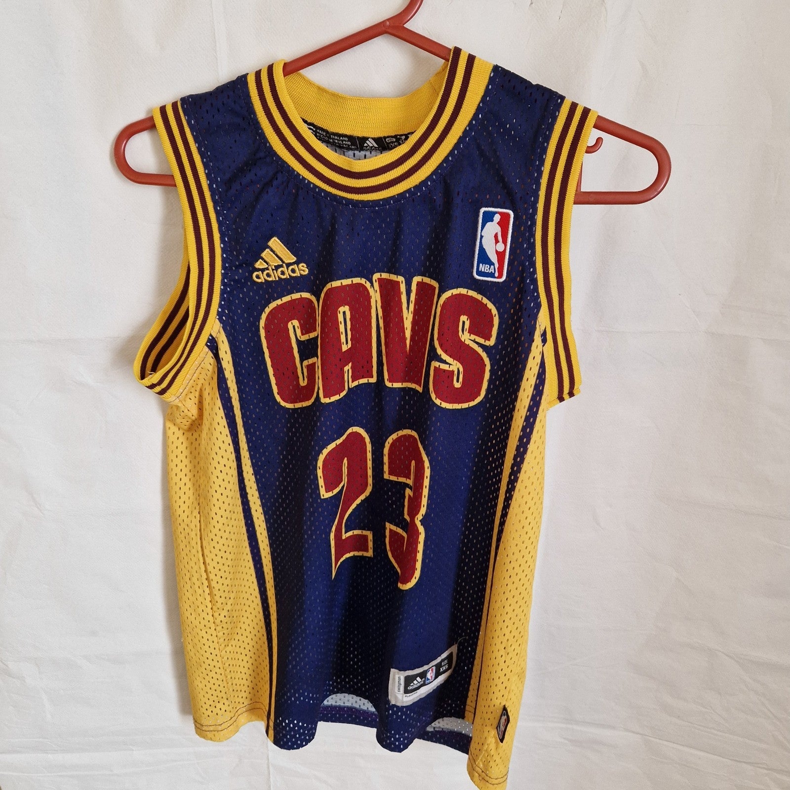 A blue and yellow Adidas LeBron James Cleveland Cavaliers basketball jersey with number 23.