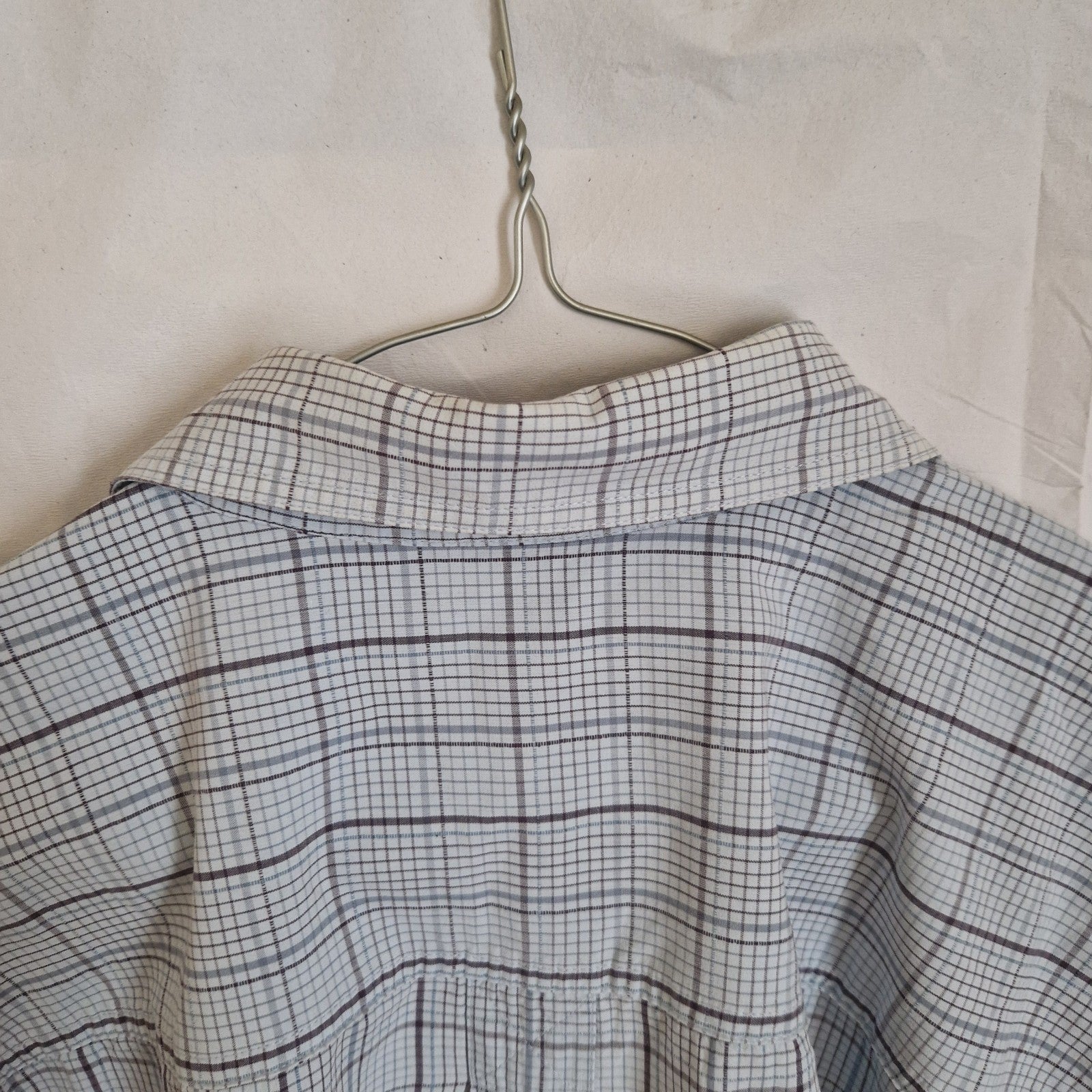 A Timberland long-sleeve shirt in a grey and blue check pattern with a button-down collar.