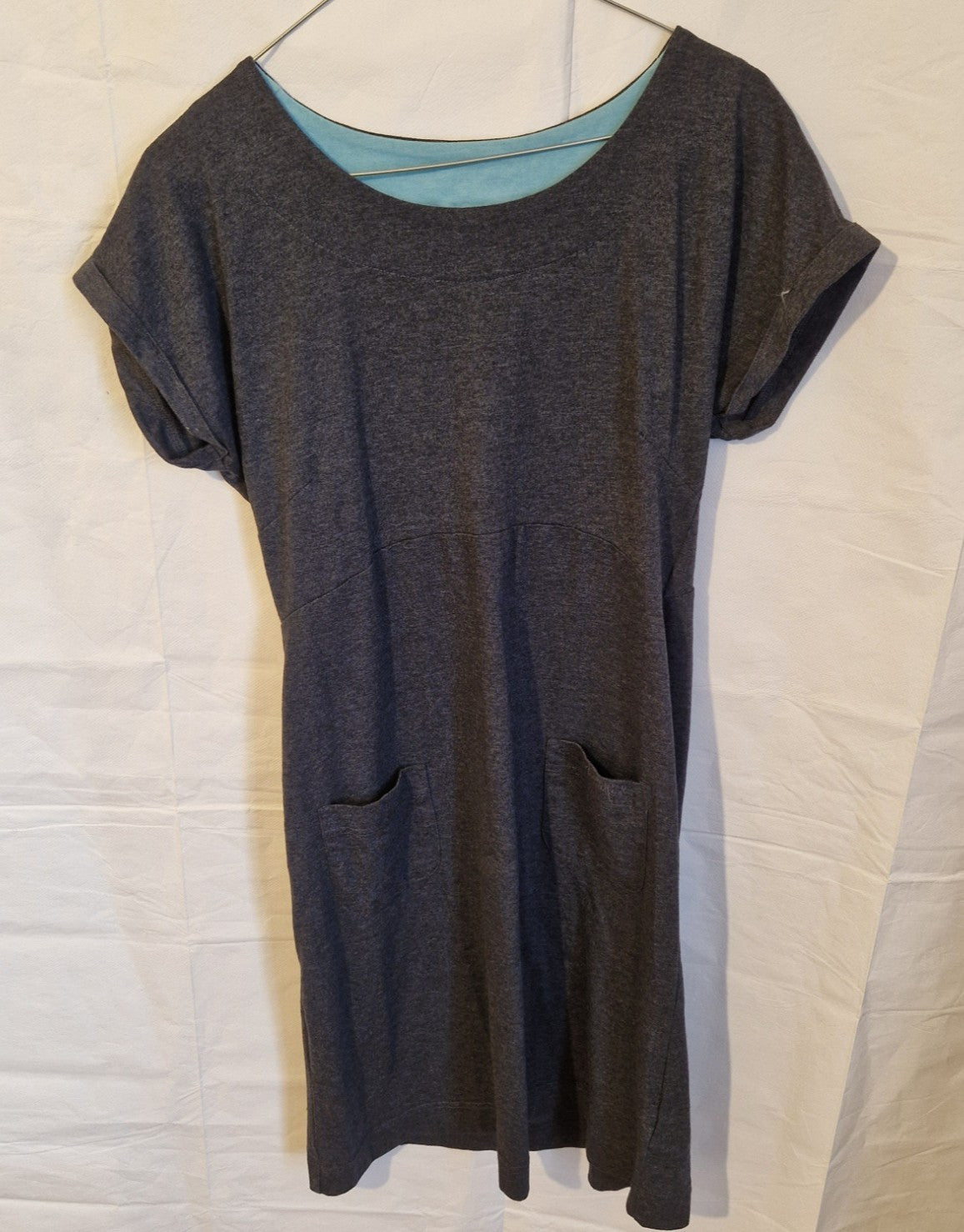 A grey Weird Fish midi shift dress with a round neck, short sleeves, and two front pockets.