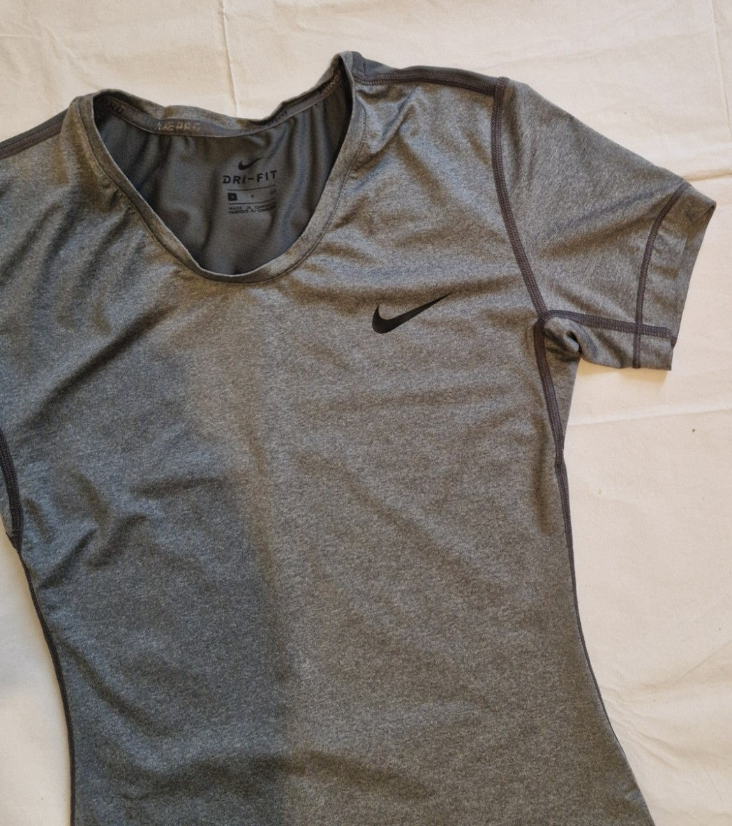 A grey Nike women's slim-fit Dri-FIT crew neck training t-shirt.
