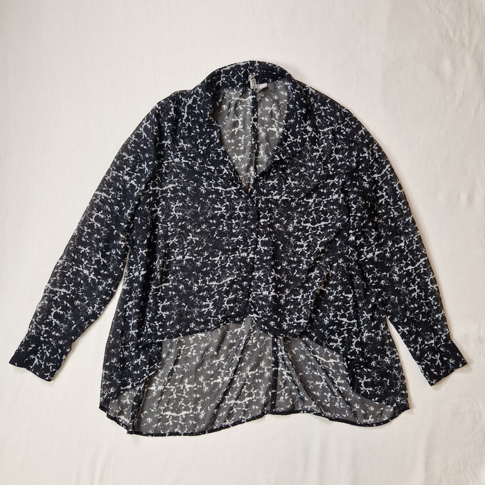 Black and white patterned shirt on a light gray background