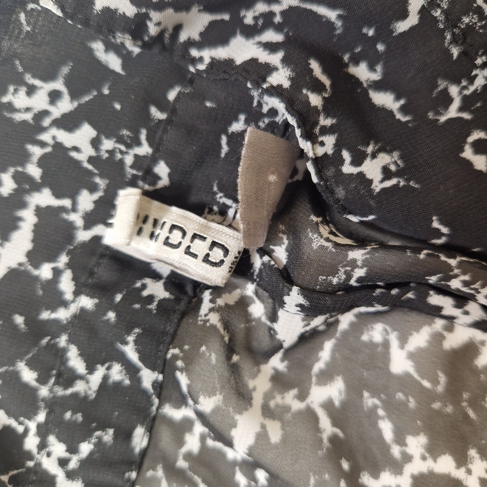 Close-up of a patterned fabric with a visible brand label.