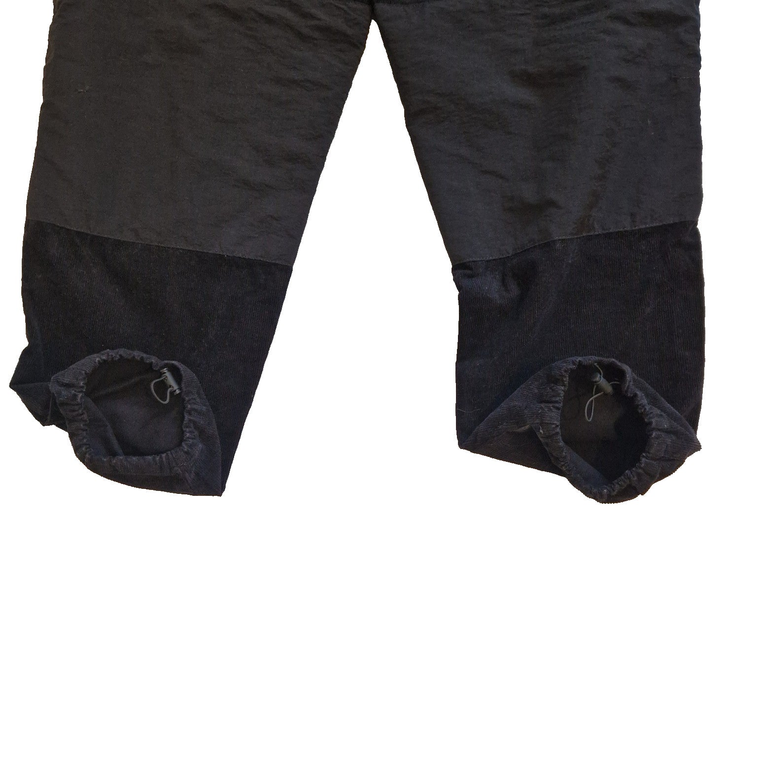 Black Zara men's tapered jogger pants featuring a patchwork design and elasticated cuffs.
