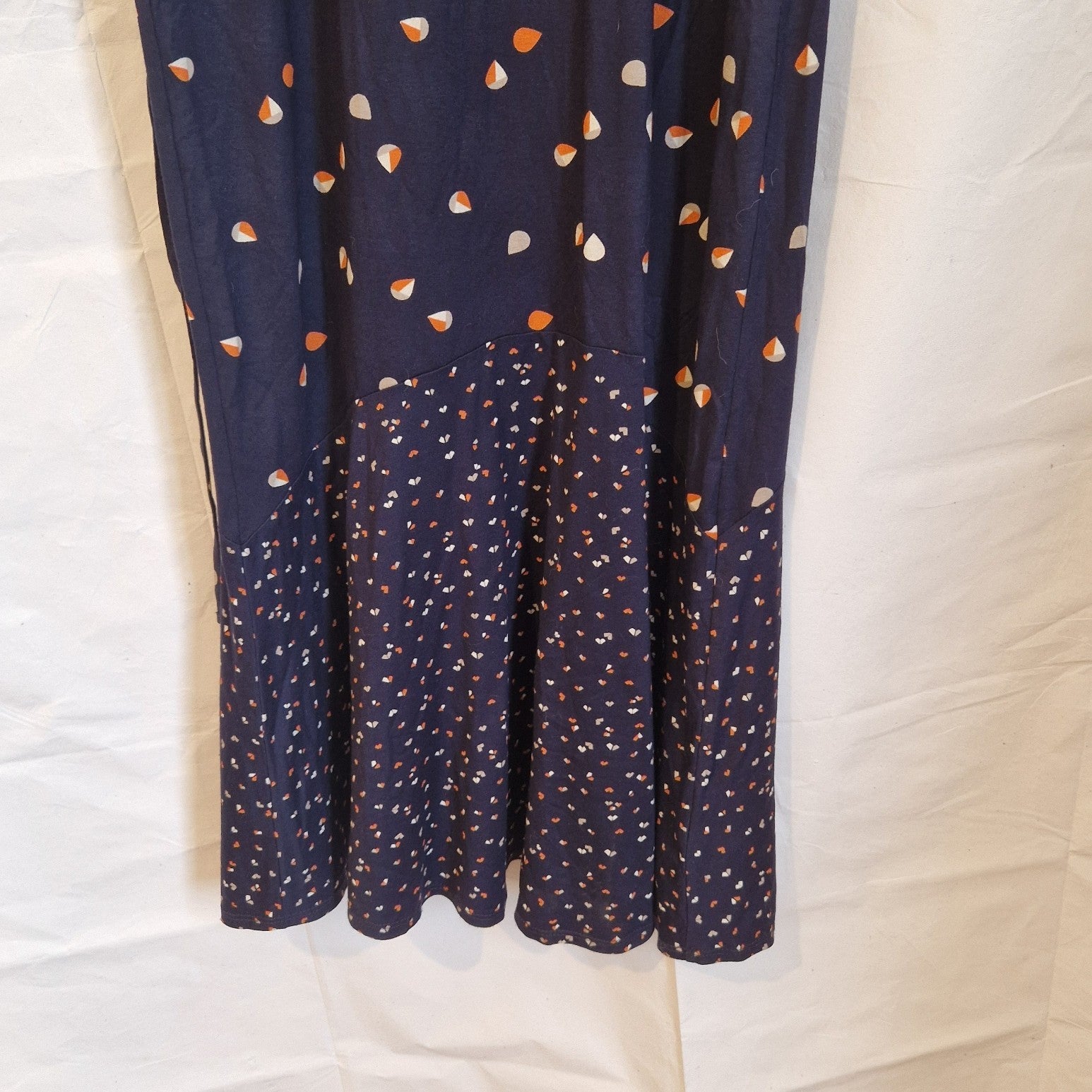 A navy blue fit and flare dress with a multicoloured floral print and a ruffled hem.