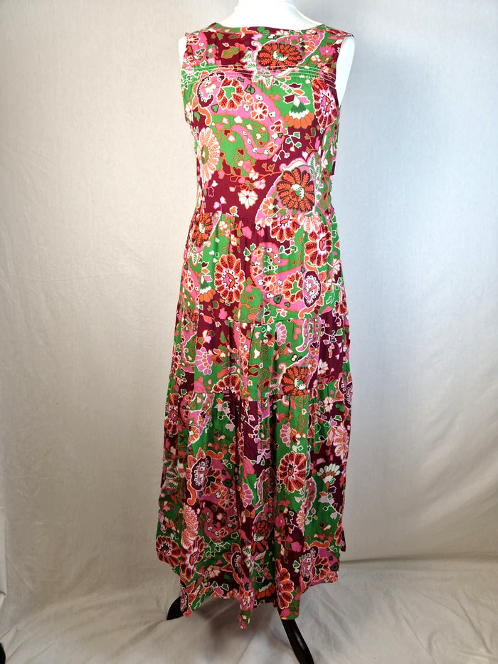 Colorful floral dress on a mannequin against a white background