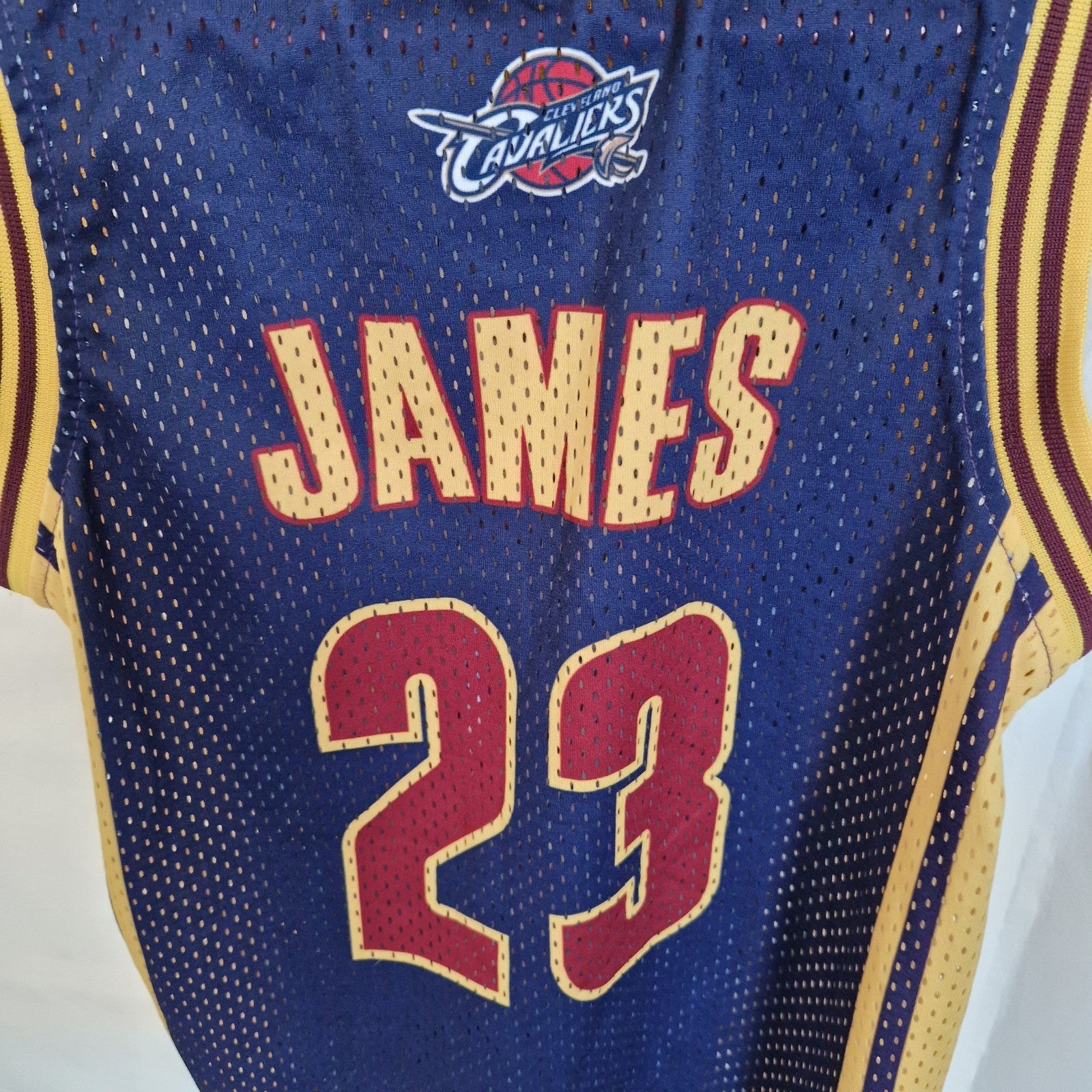 A navy blue Cleveland Cavaliers LeBron James number 23 basketball jersey by Adidas.