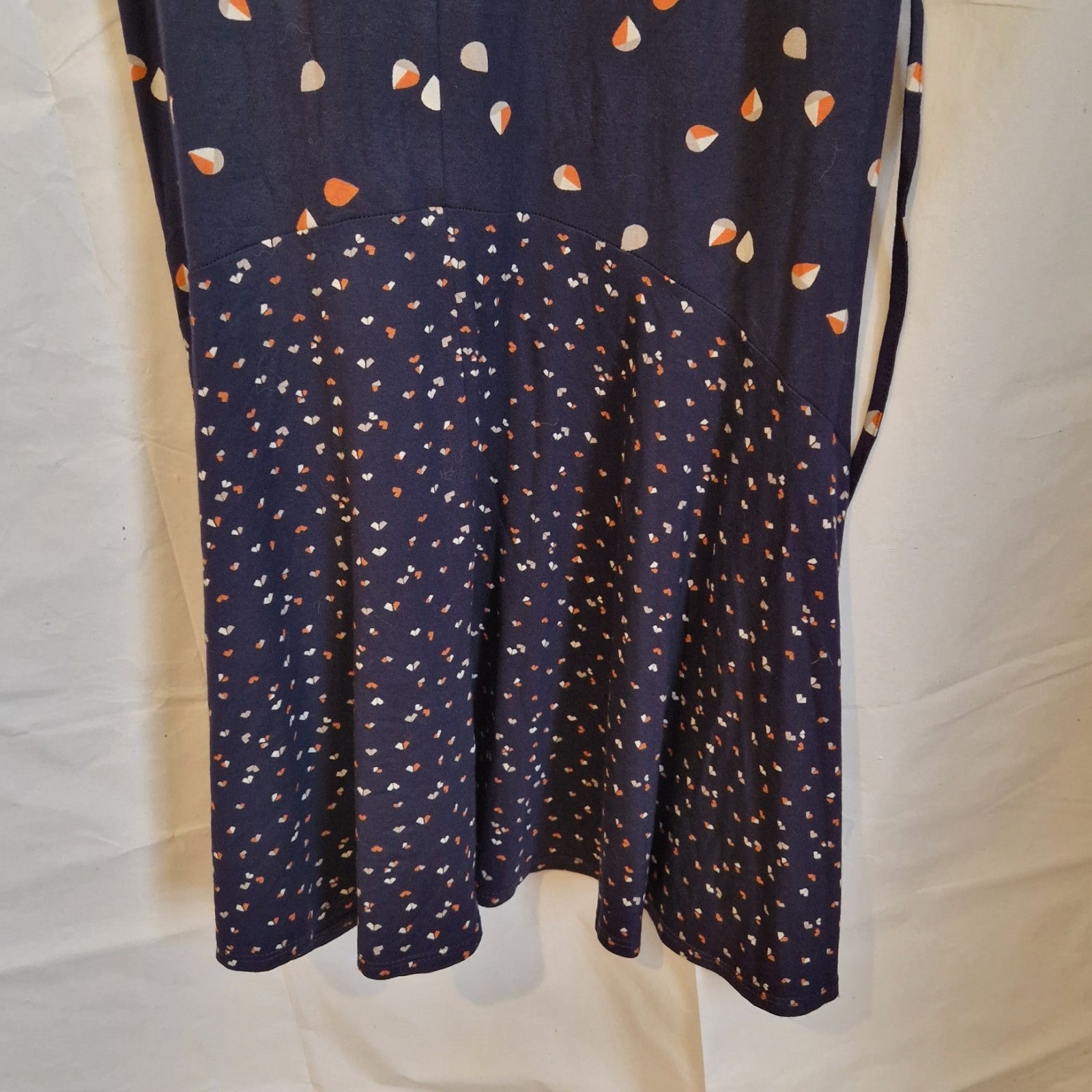 A navy blue fit and flare dress featuring a two-tone pattern of teardrops and small floral prints.