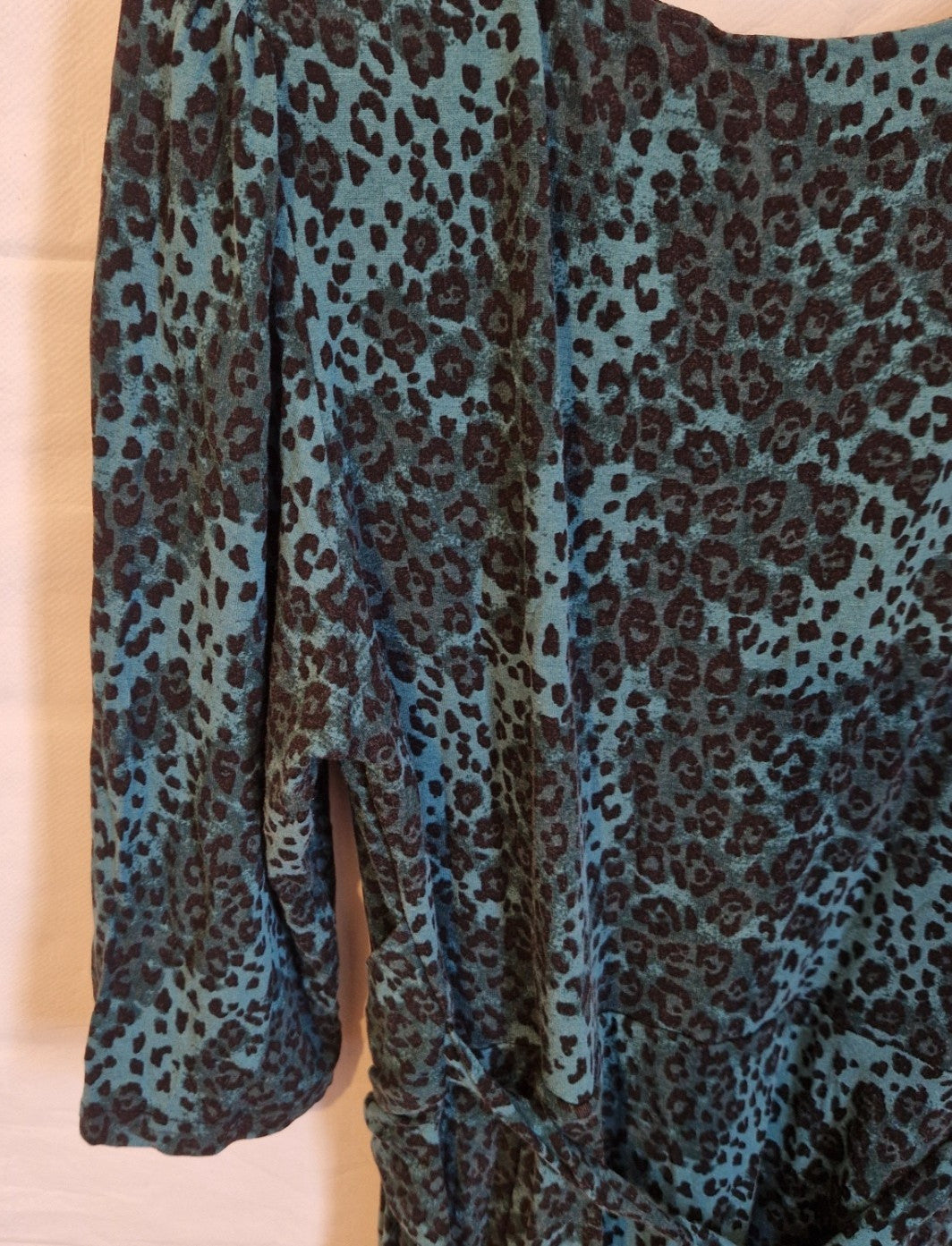 A teal and black leopard print long-sleeved maxi dress made from a flowing chiffon blend.