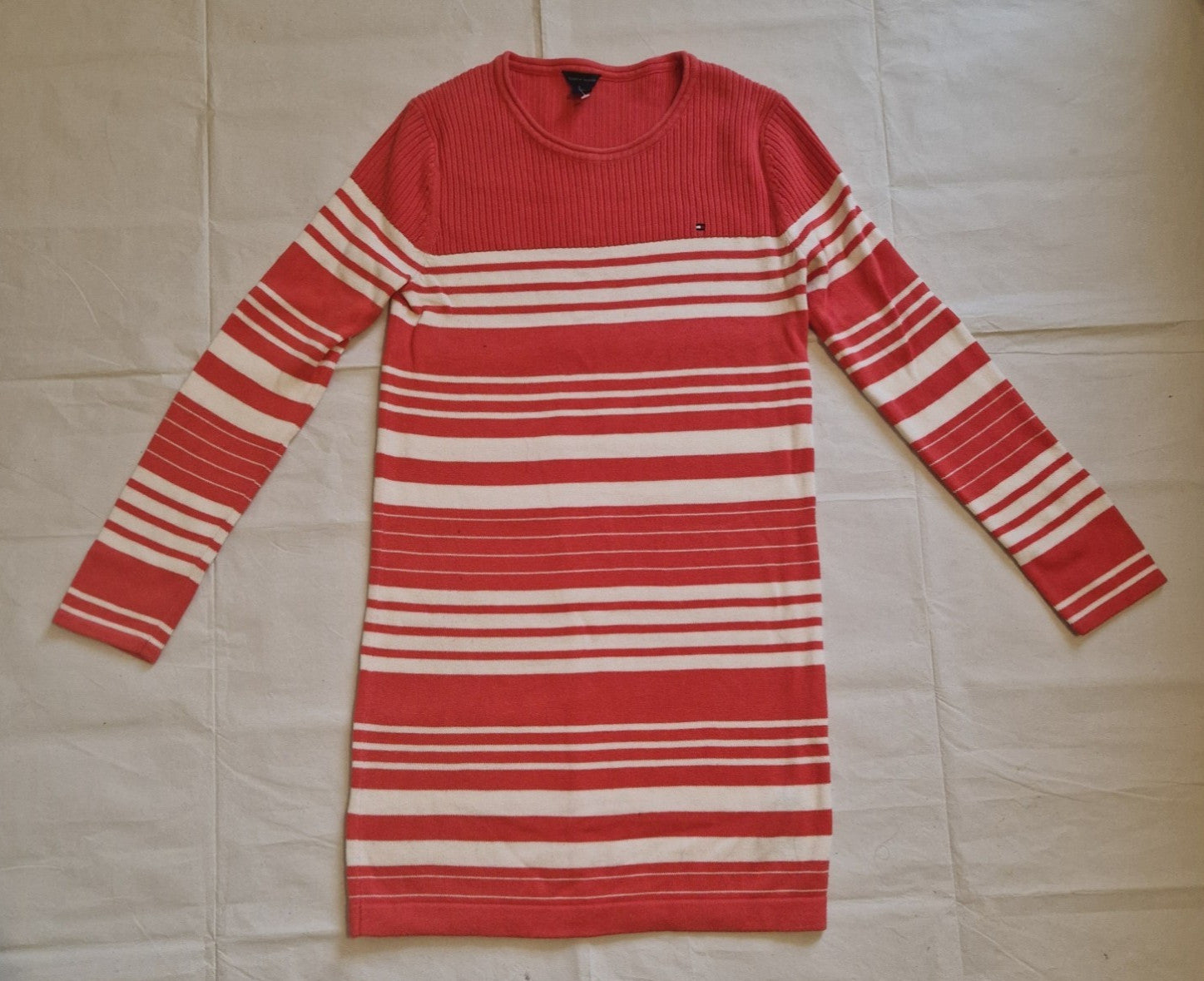 A red and white striped Tommy Hilfiger knitted jumper dress with a crew neck and long sleeves.